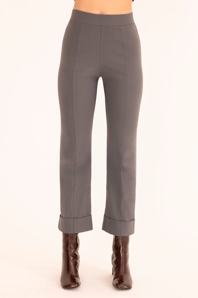 Gray pants worn by a person on a white background