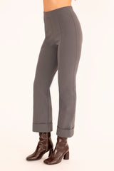 Gray pants worn by a person on a white background