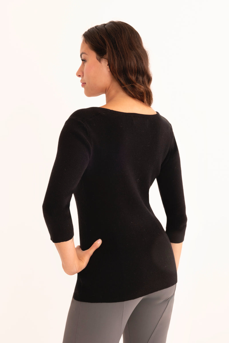 Woman wearing a black sweater white background