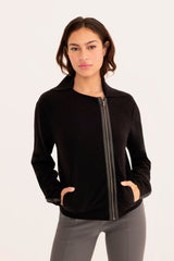 Woman wearing a black moto sweater on a white background