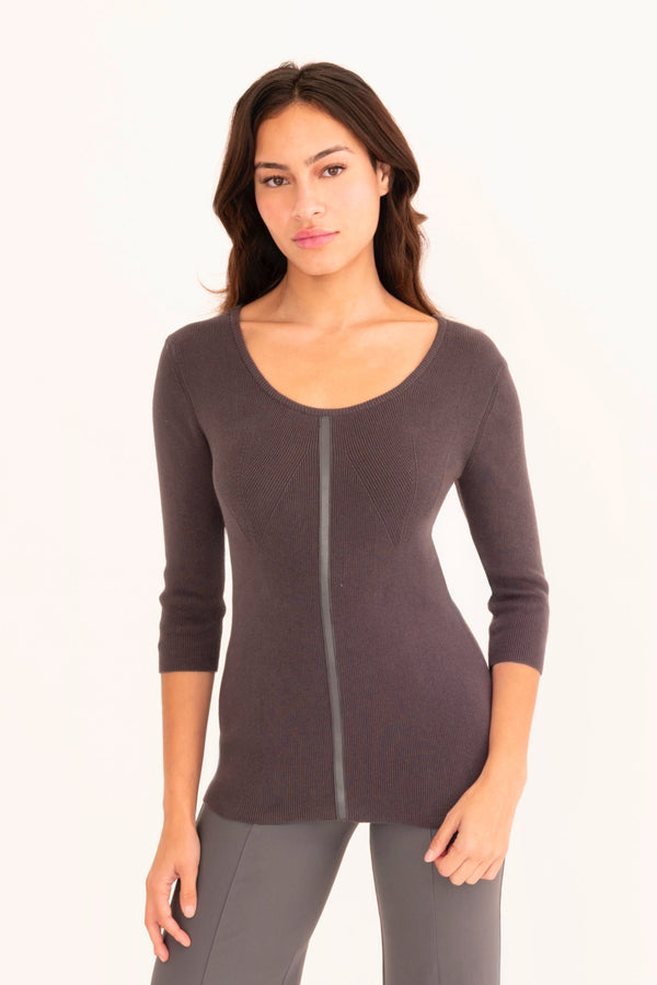 Woman wearing a dark grey sweater white background