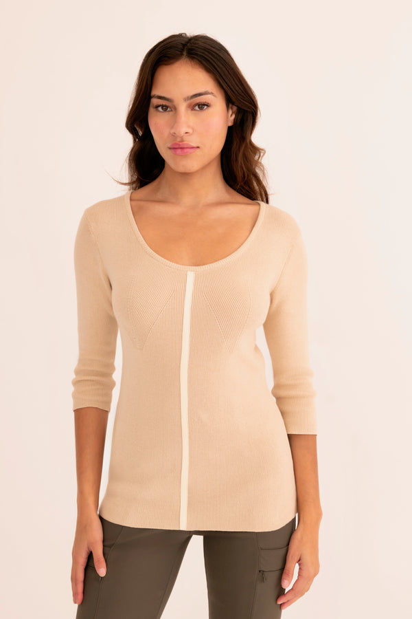 Woman wearing a light beige sweater white background