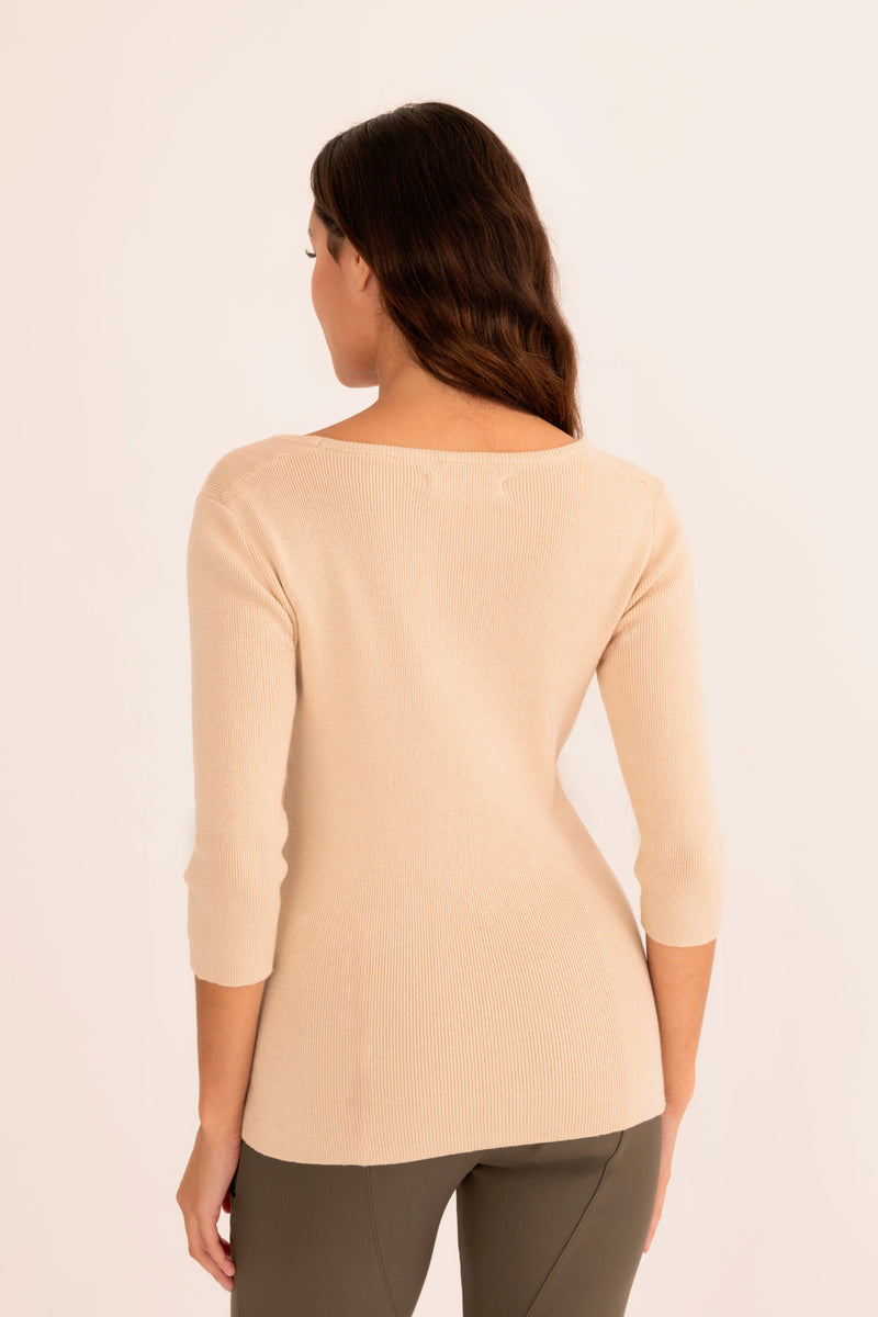 Woman wearing a light beige sweater white background