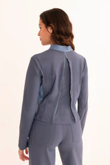 Woman wearing a gray suit on a white background