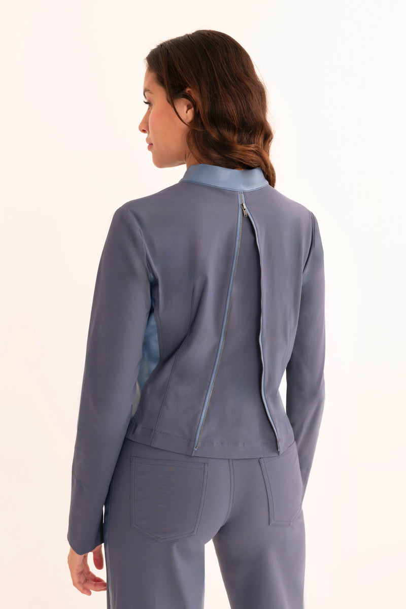 Woman wearing a gray suit on a white background