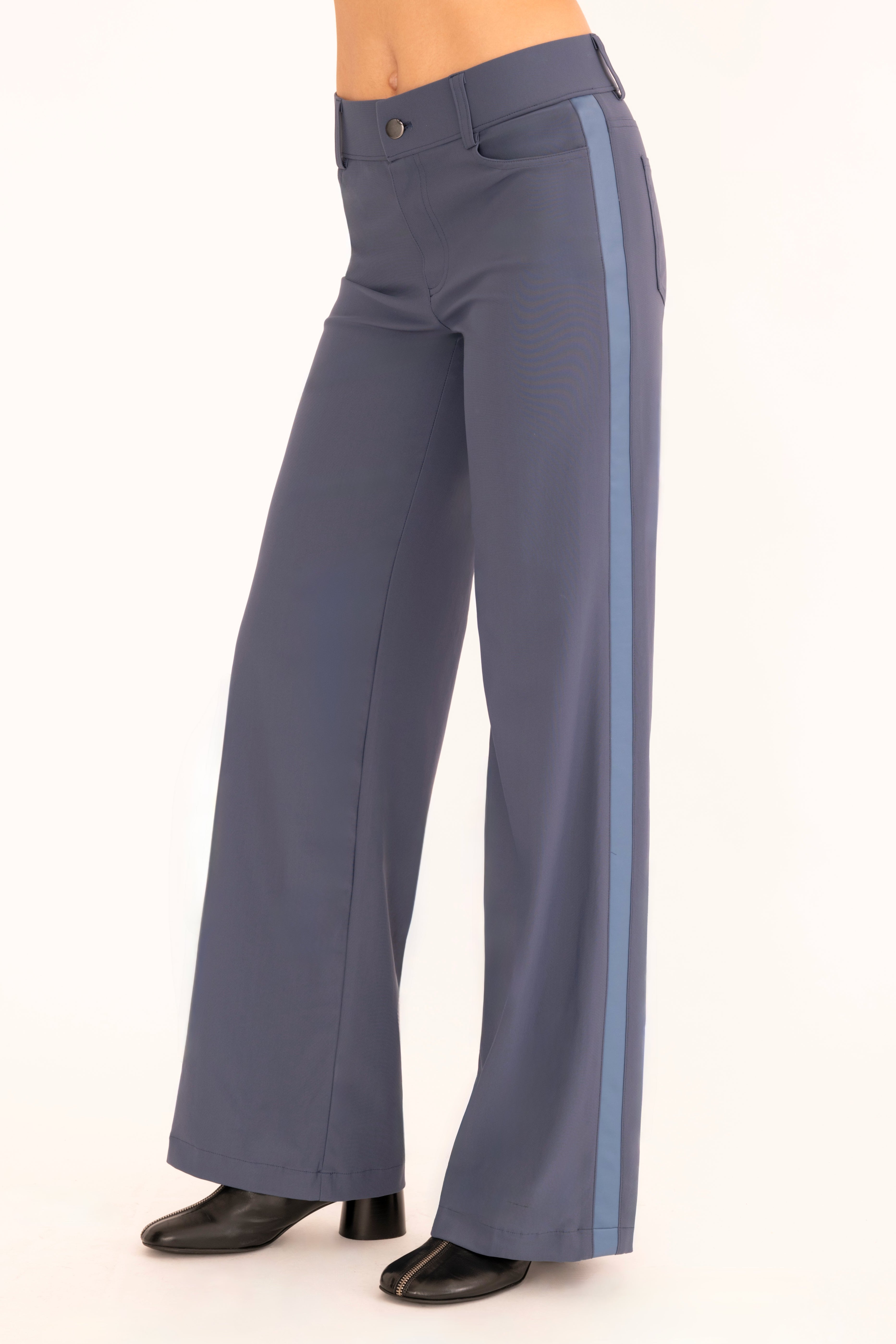 Side view of blue wide leg jean pants on a white background