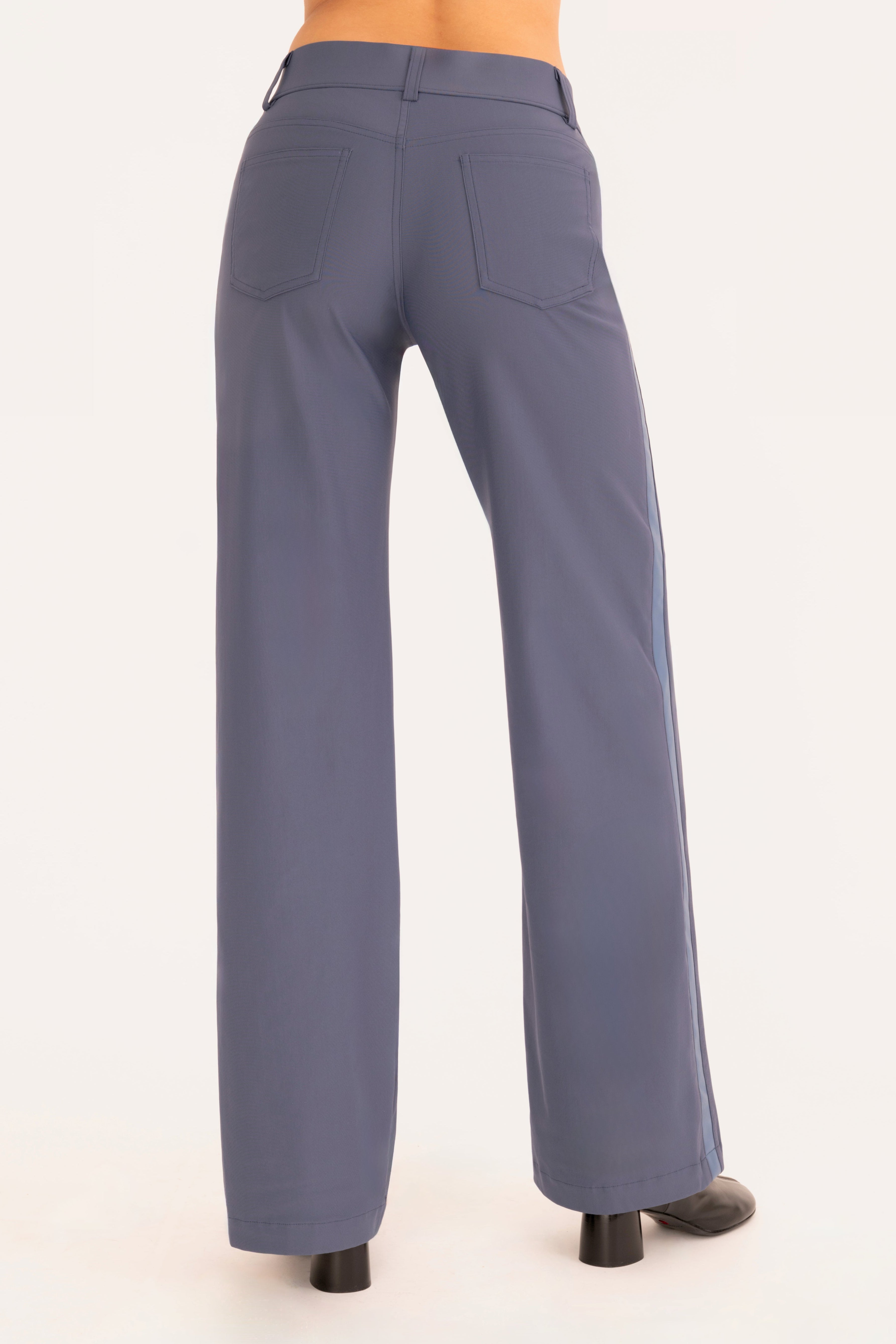 Back view of blue wide leg jean pants on a white background