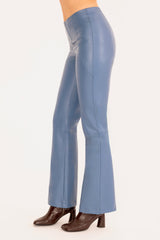 Blue flared pants worn by a person on a white background