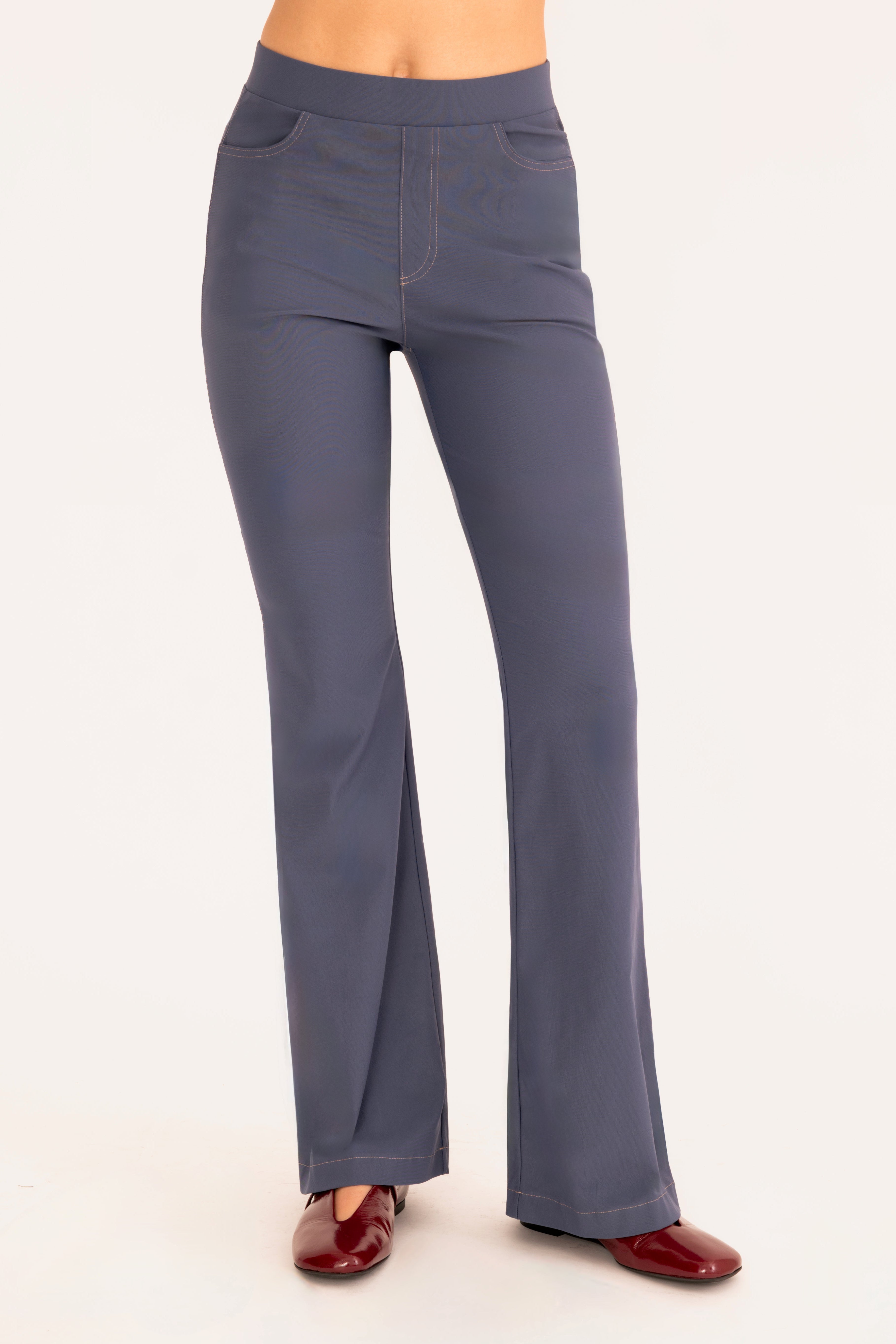 Front view of blue flare jean pants on a white background