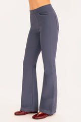 Blue flared pants worn by a person on a white background