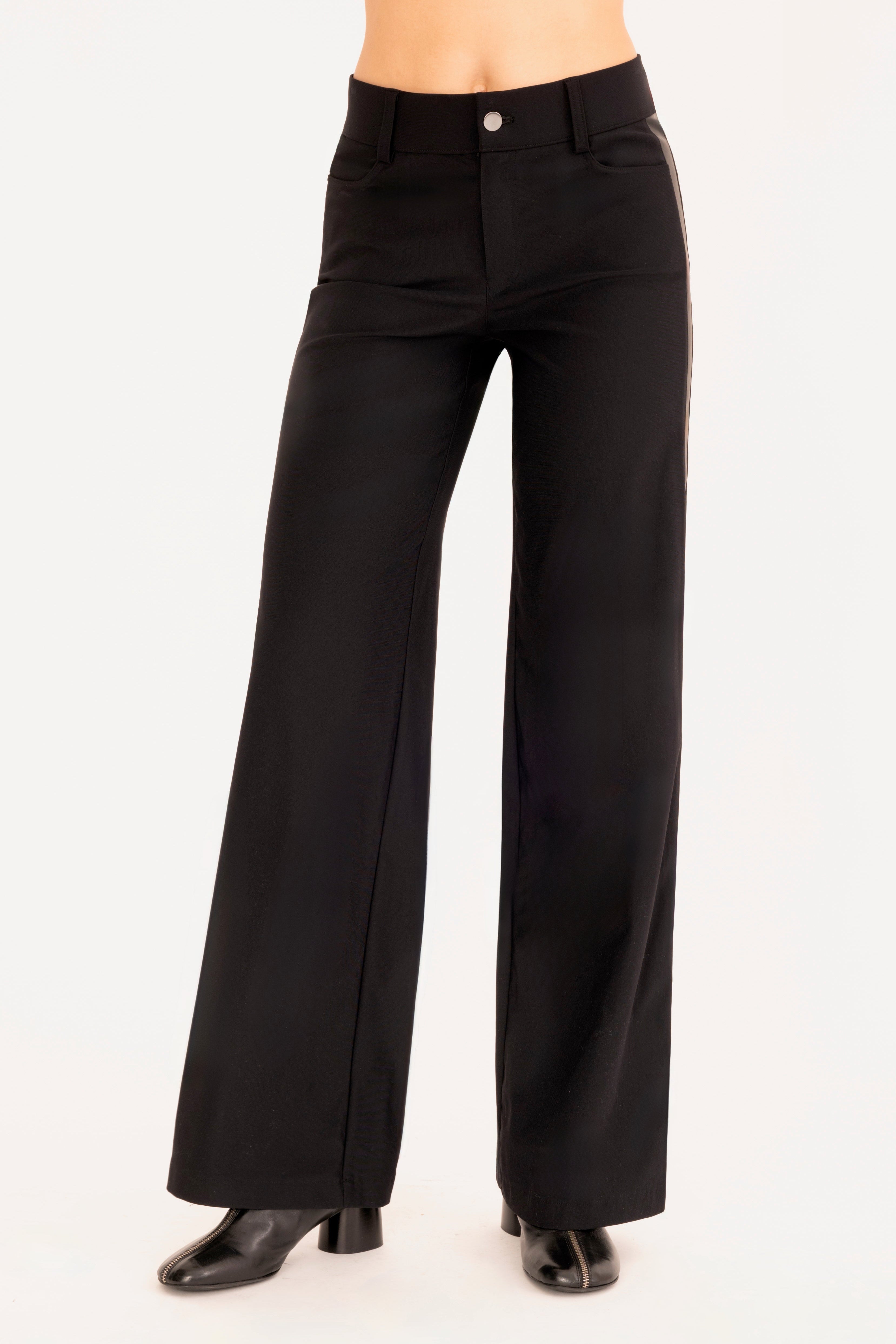 Front view of black wide leg jean pants on a white background