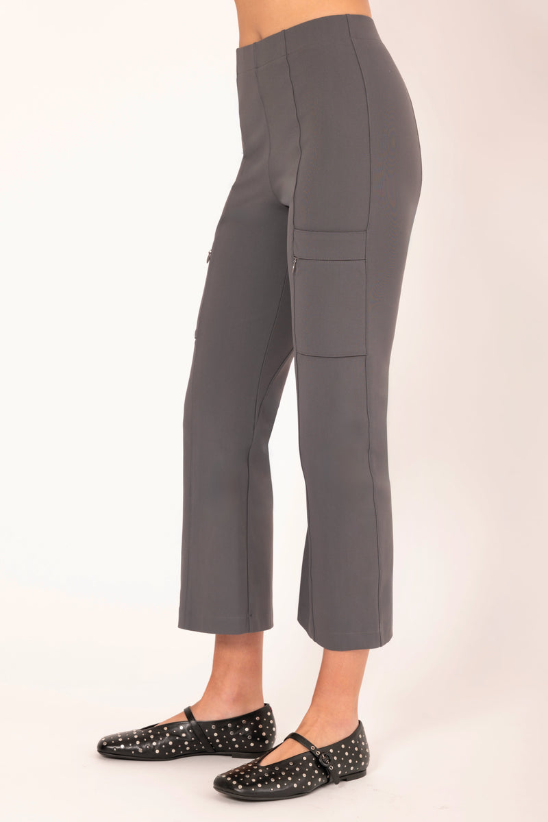 Person wearing gray cargo pants on a white background