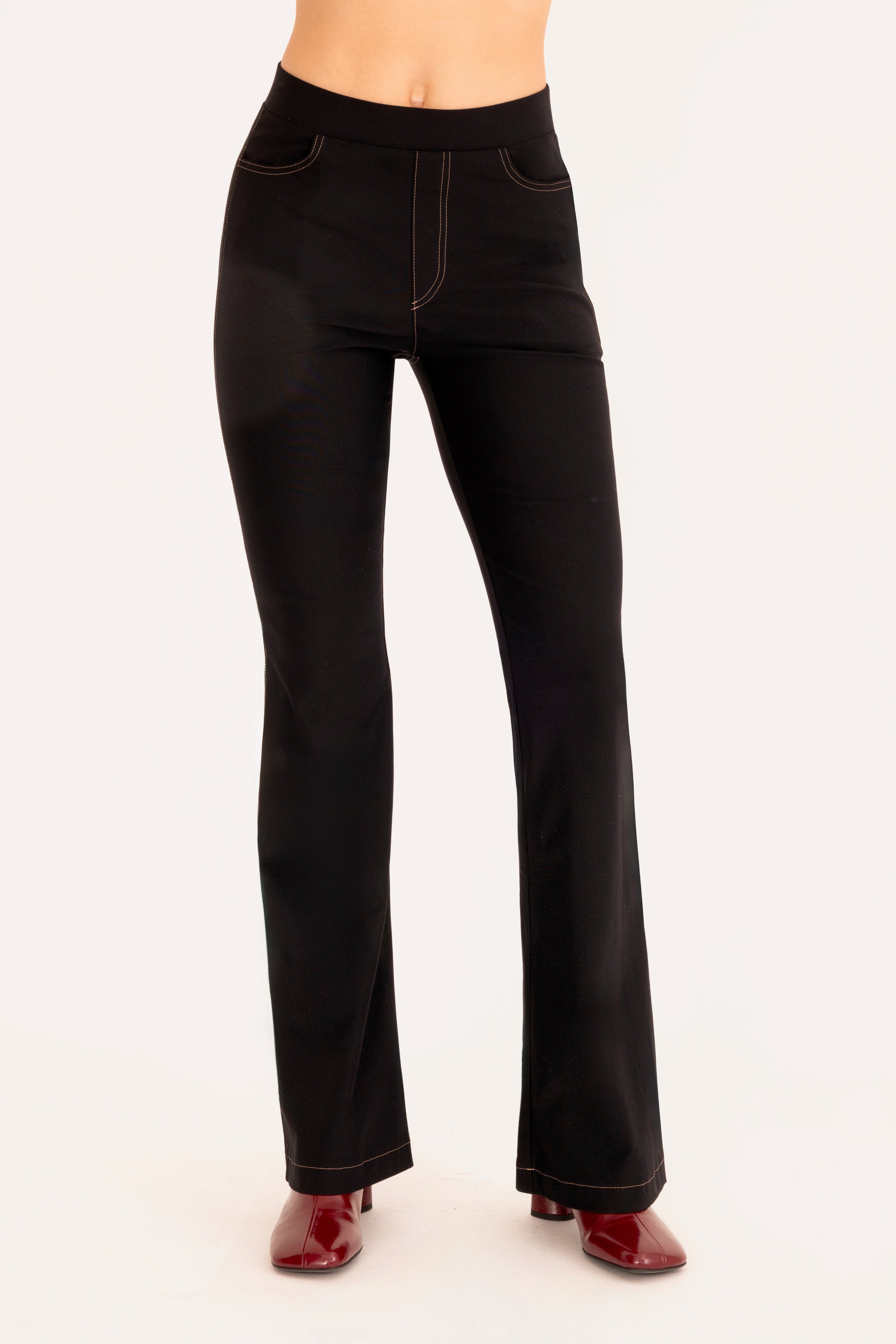 Front view of black flare jean pants on a white background