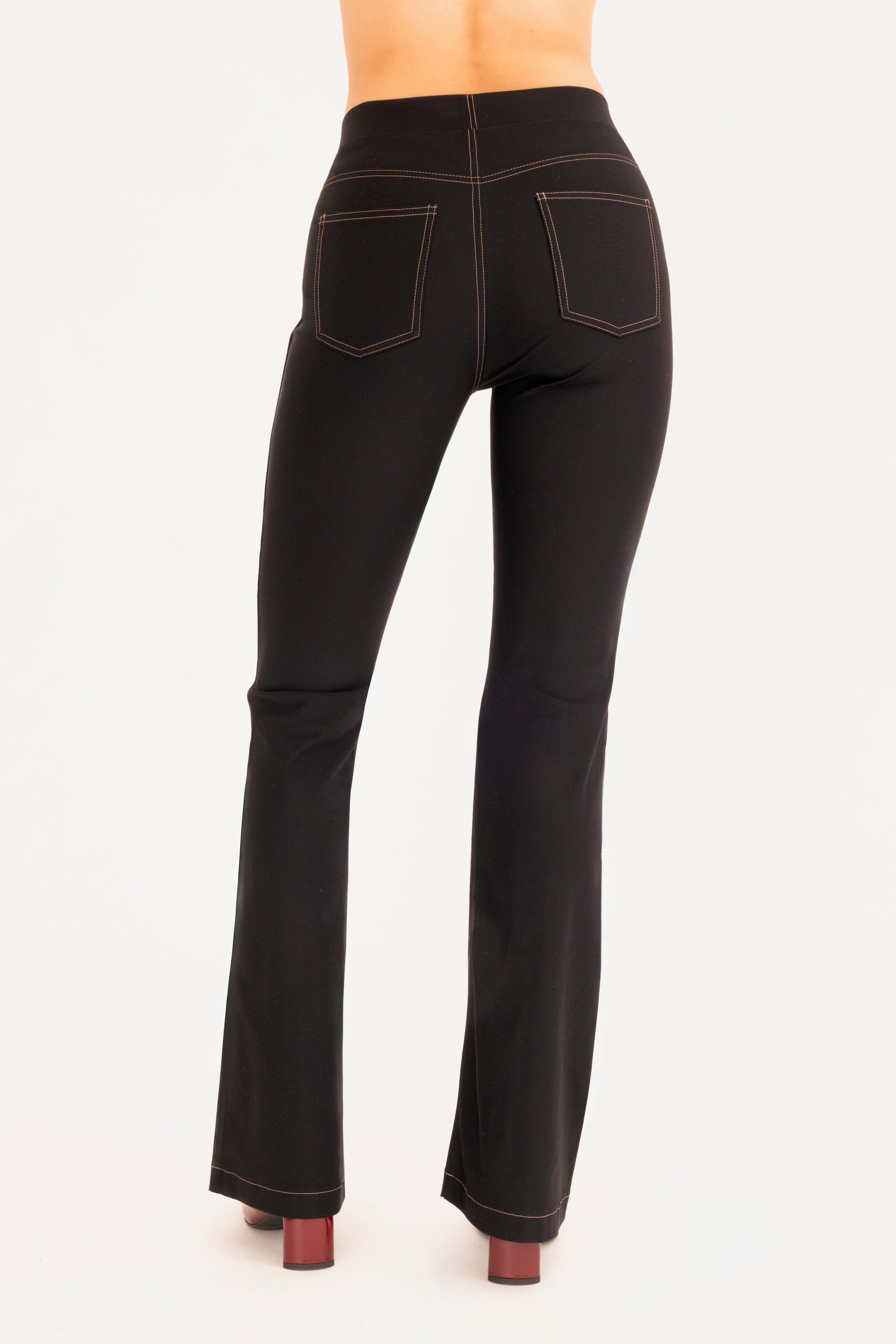 Back view of black flare jean pants on a white background
