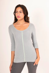 Woman wearing a light blue sweater white background