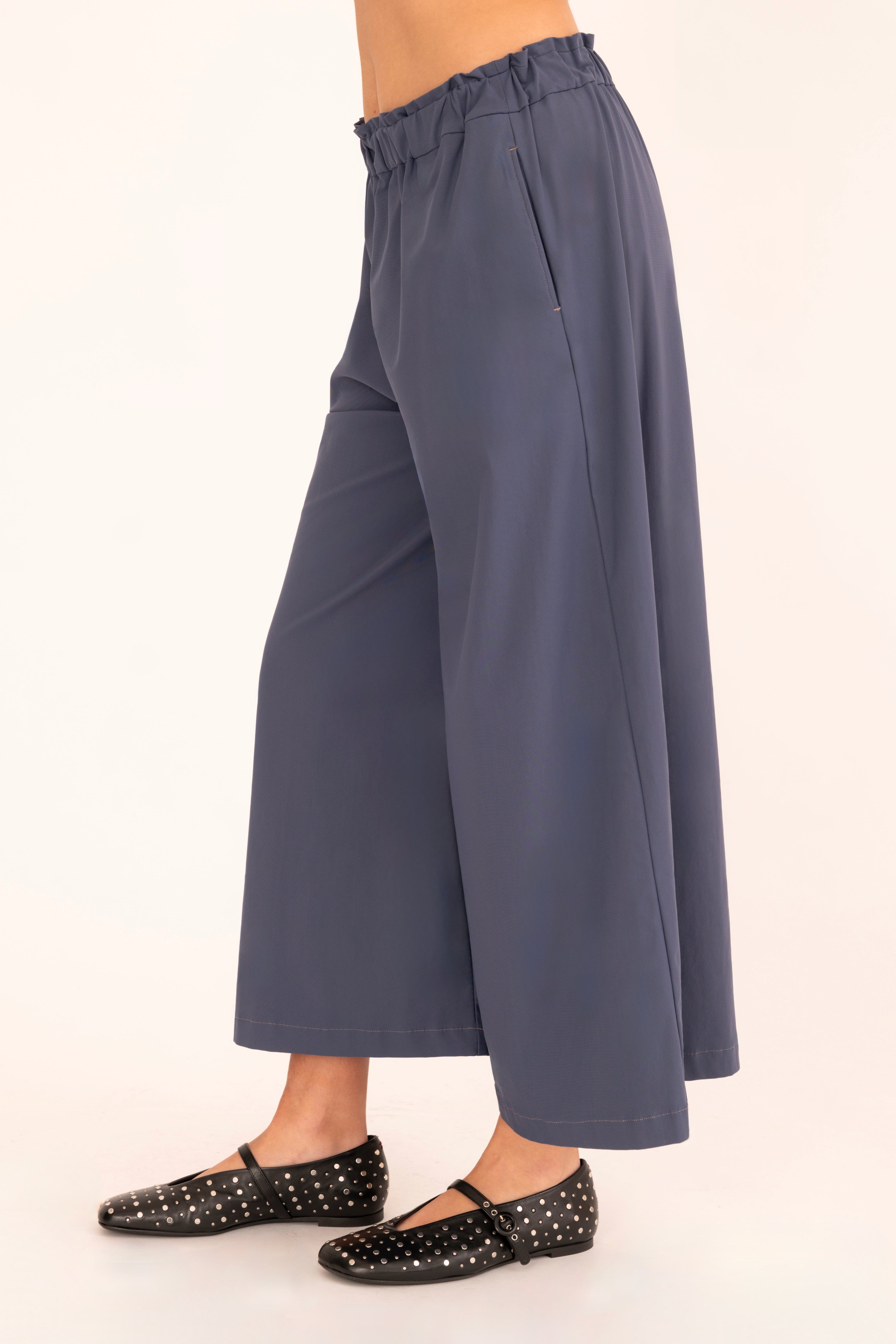 Side view of blue culotte pant on a white background