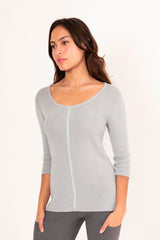 Woman wearing a light blue sweater white background