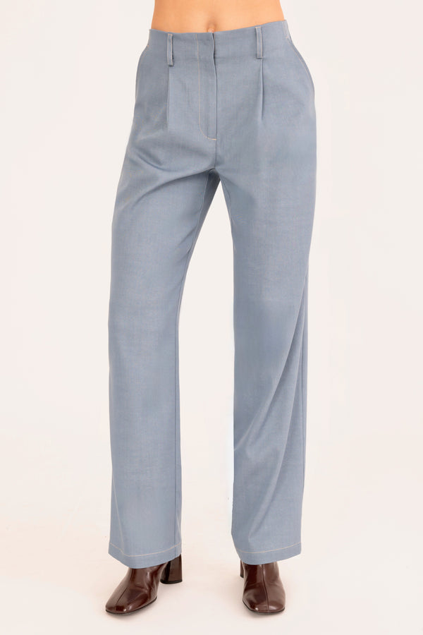 Light blue pants worn by a person on a white background