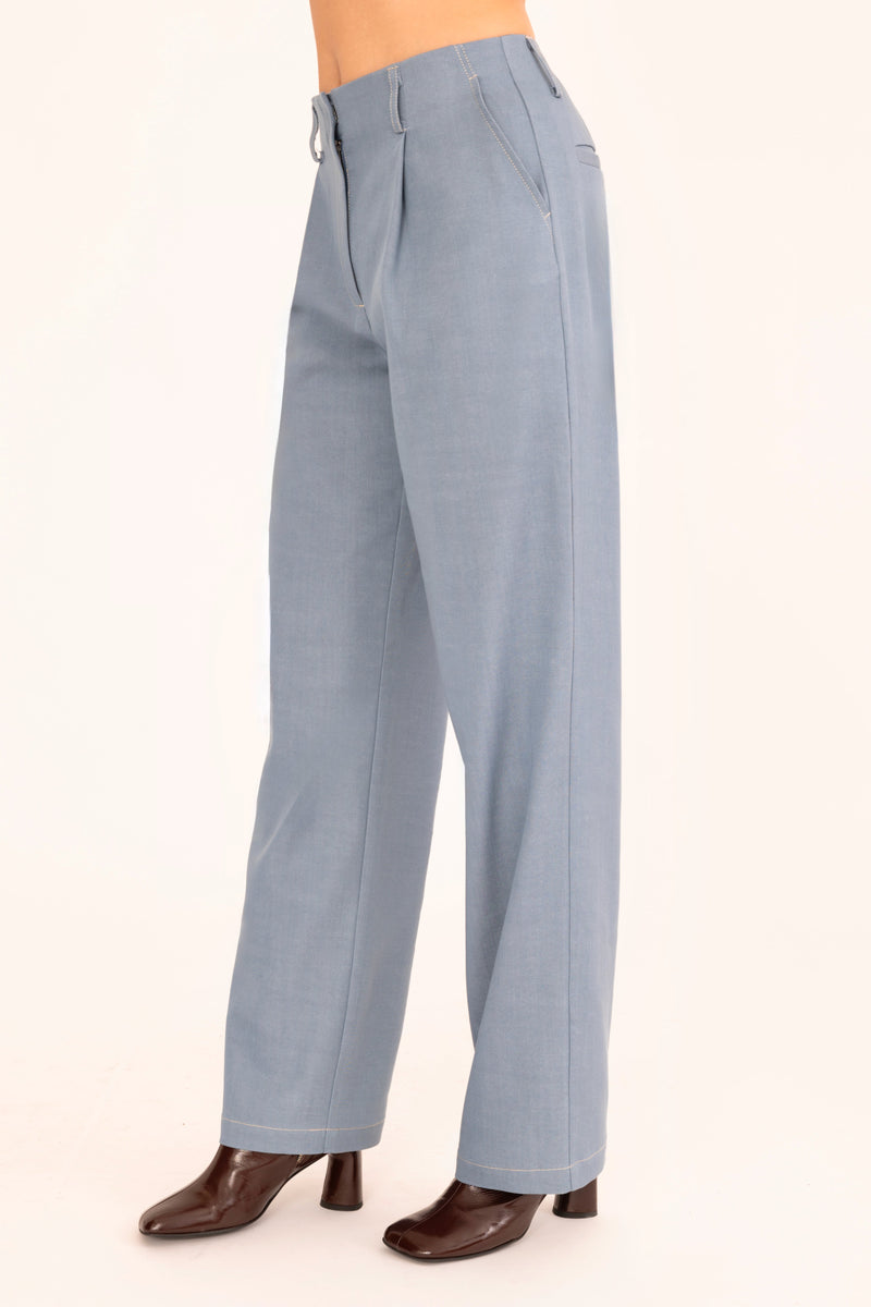 Light blue pants worn by a person on a white background