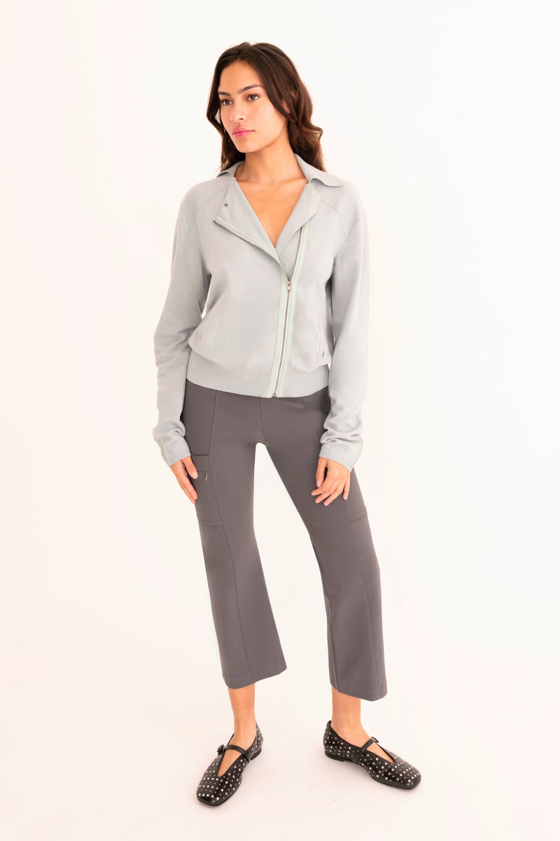 Woman wearing a gray outfit on a white background