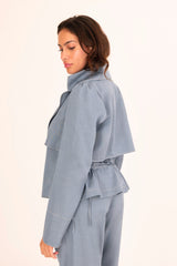 Woman wearing a light blue outfit on a white background