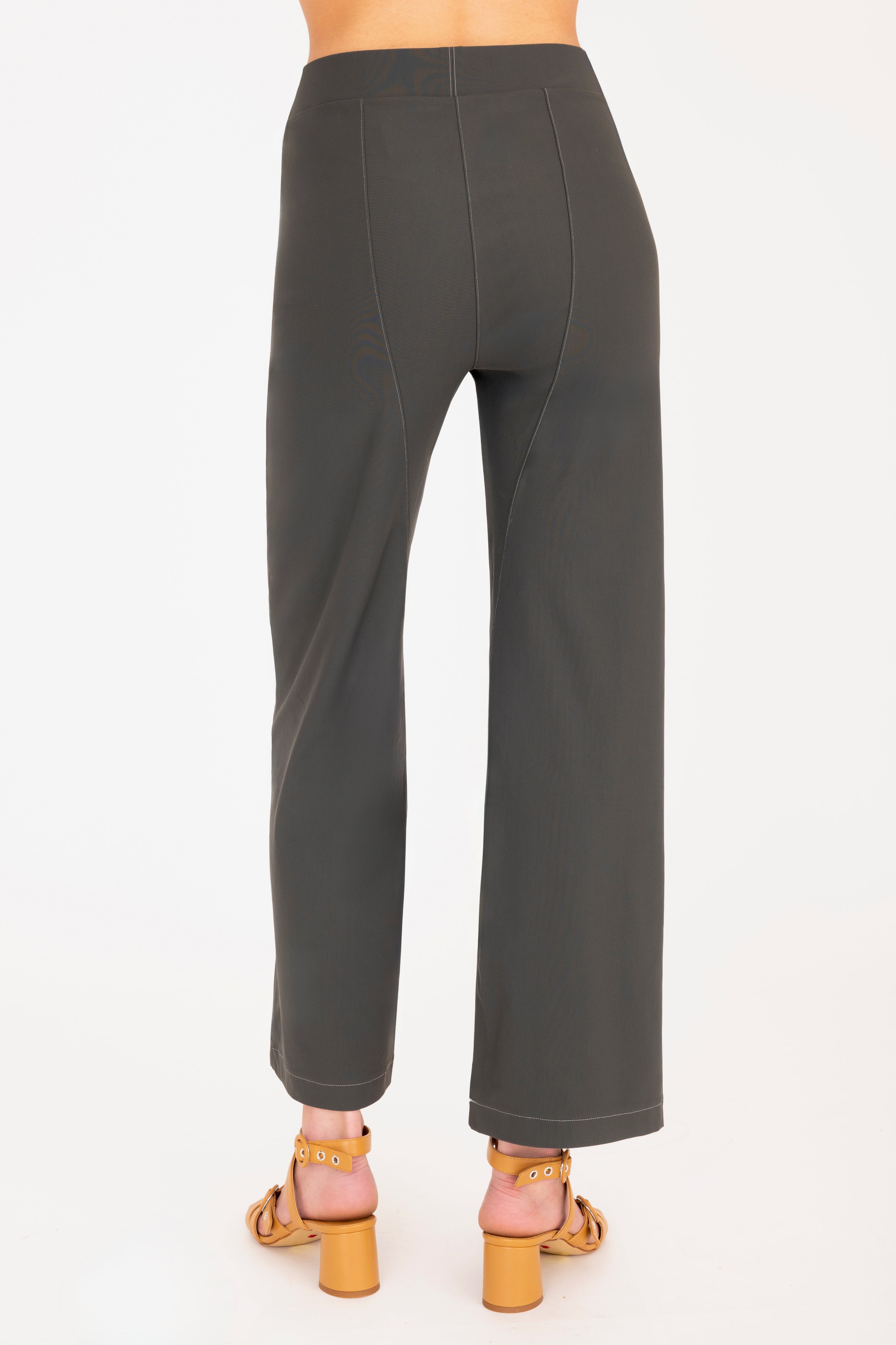Olive green pants worn by a person on a white background