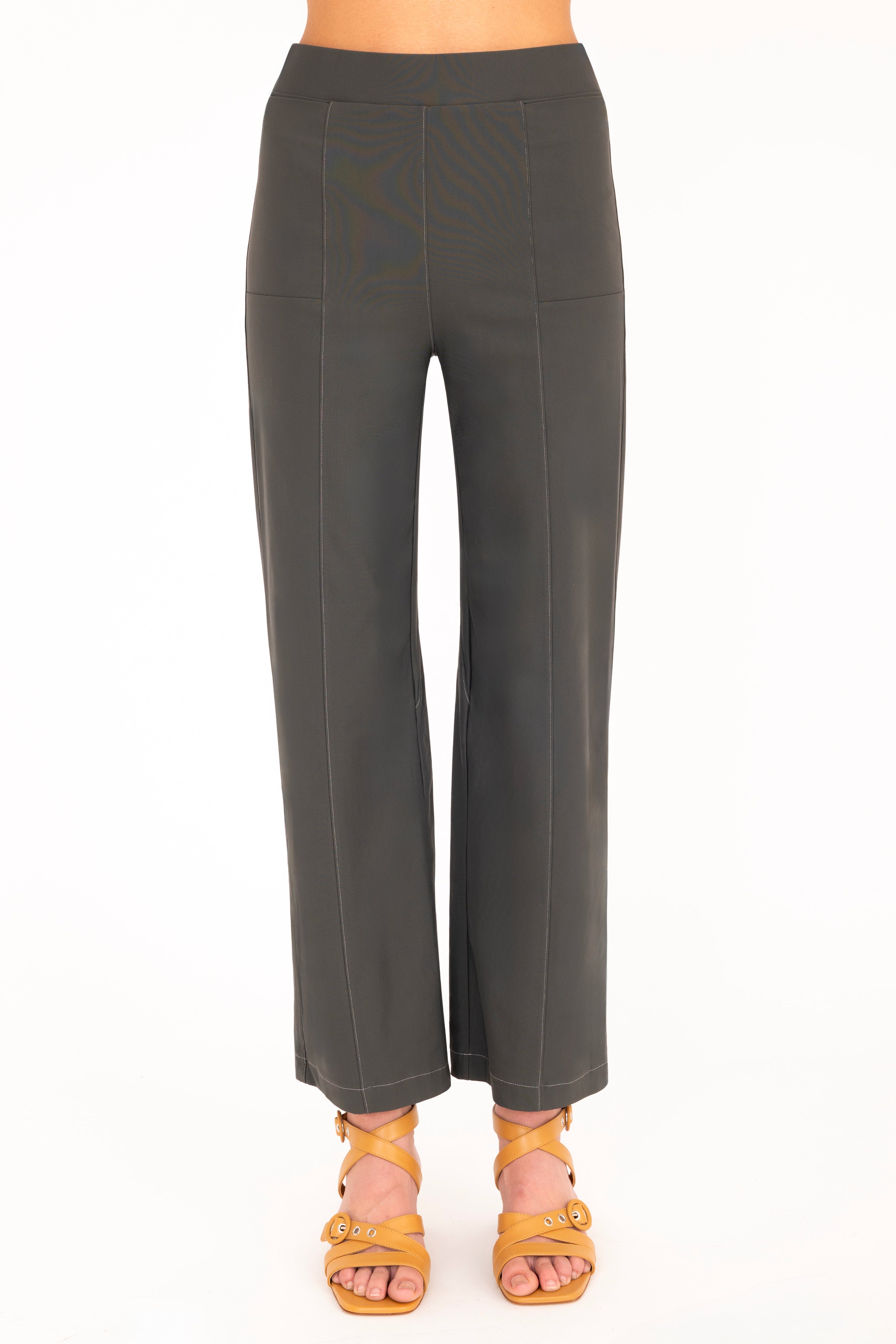 Olive green pants worn by a person on a white background