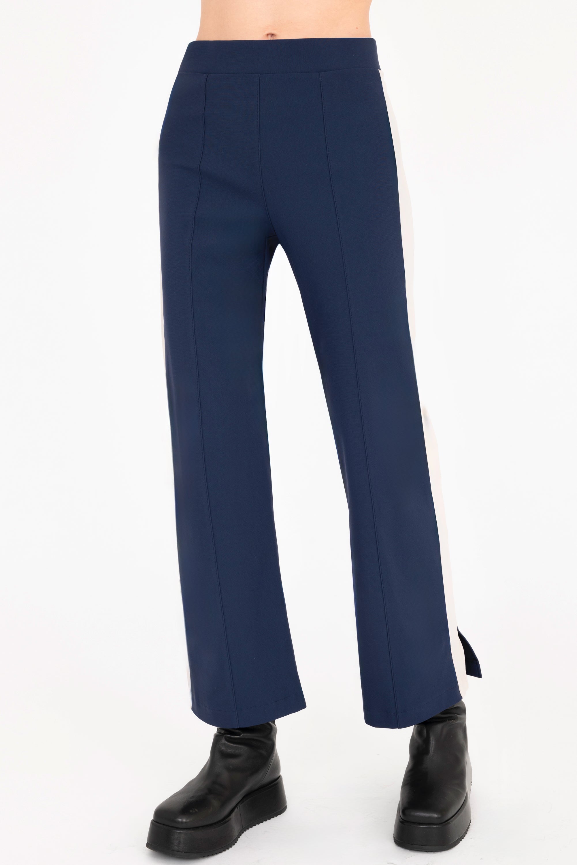 Front view of indigo blue cropped pants with beige side stripe on a white background