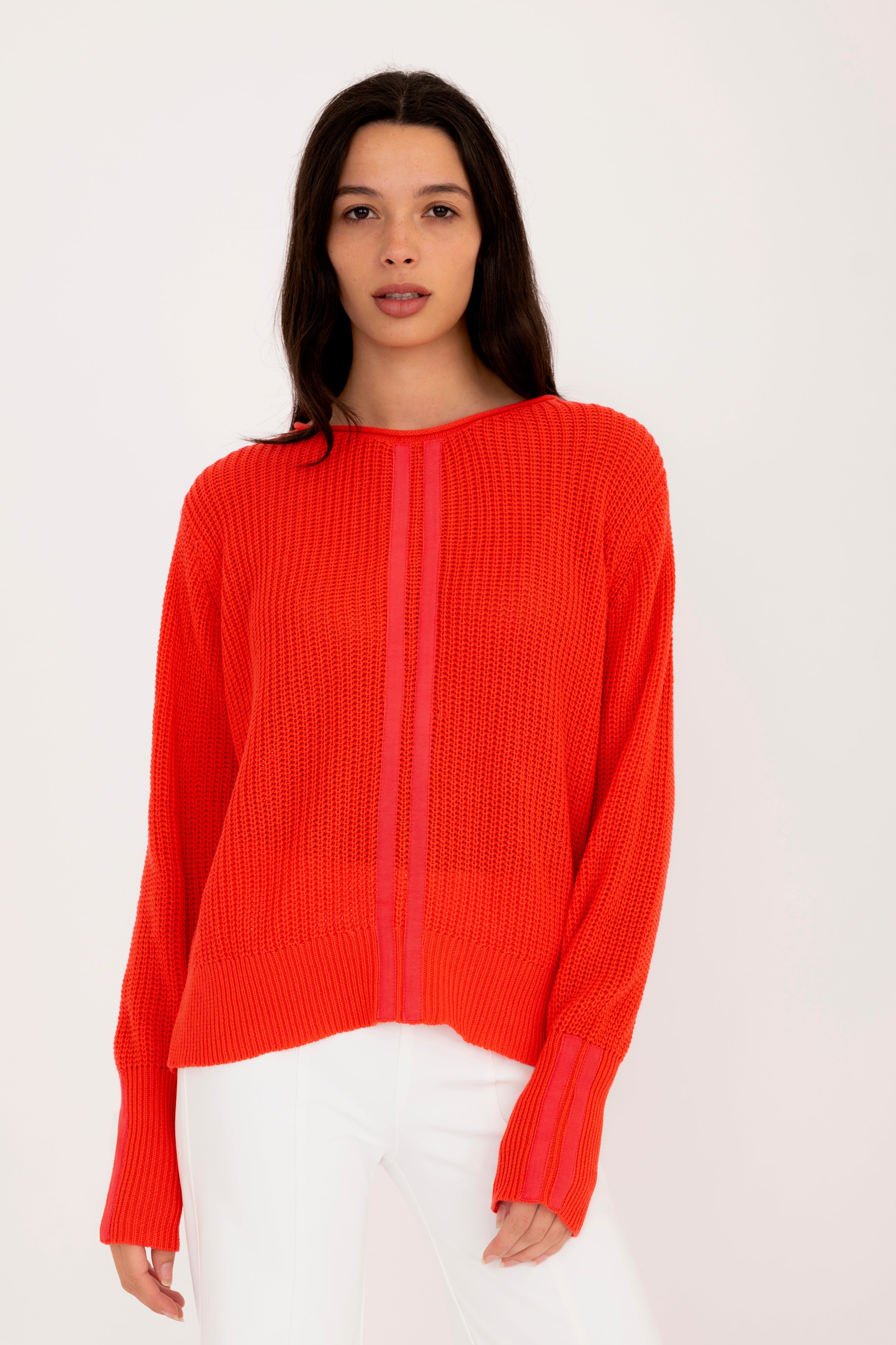 Woman wearing a orange sweater on a white background