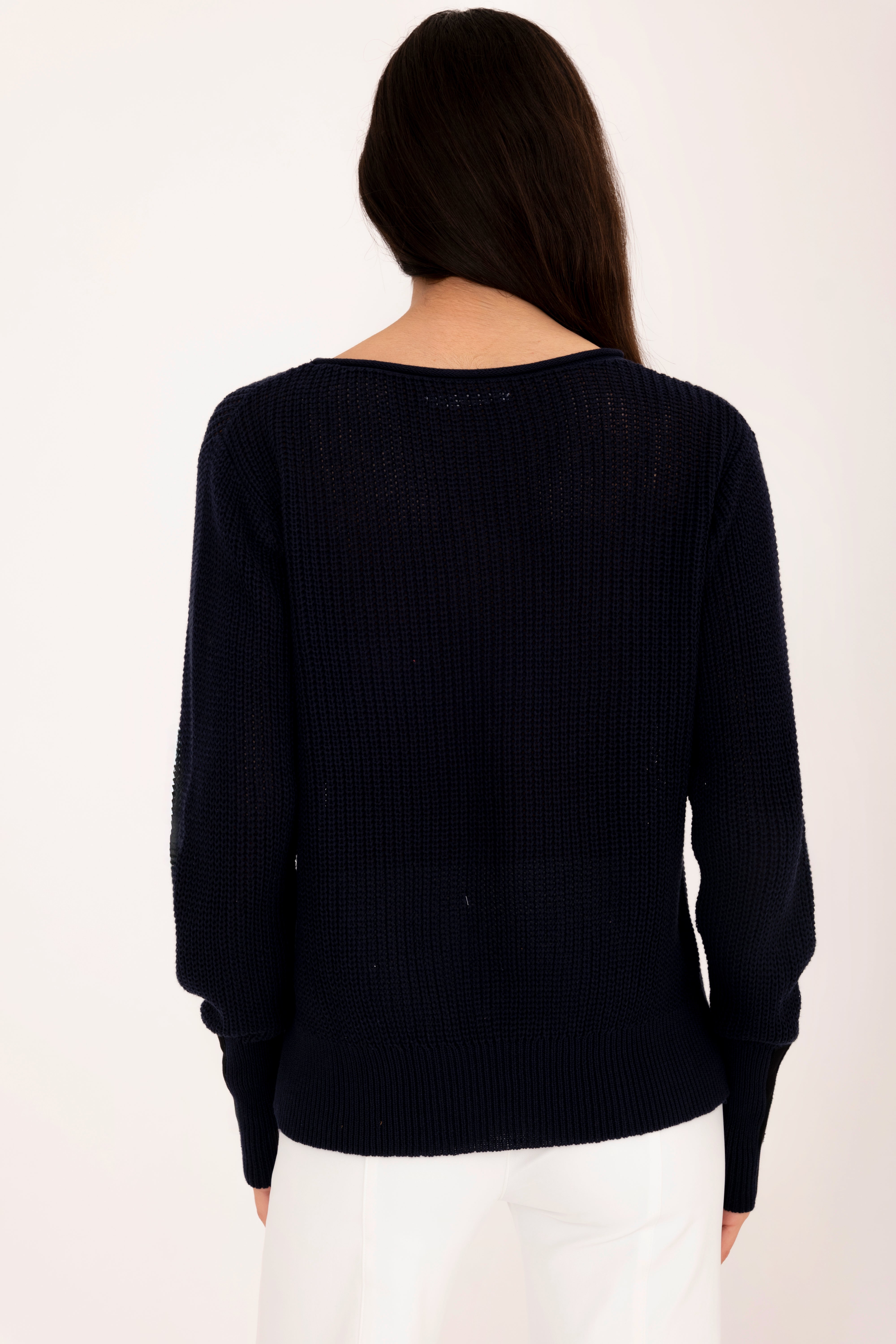 Woman wearing a pink sweater on a white background