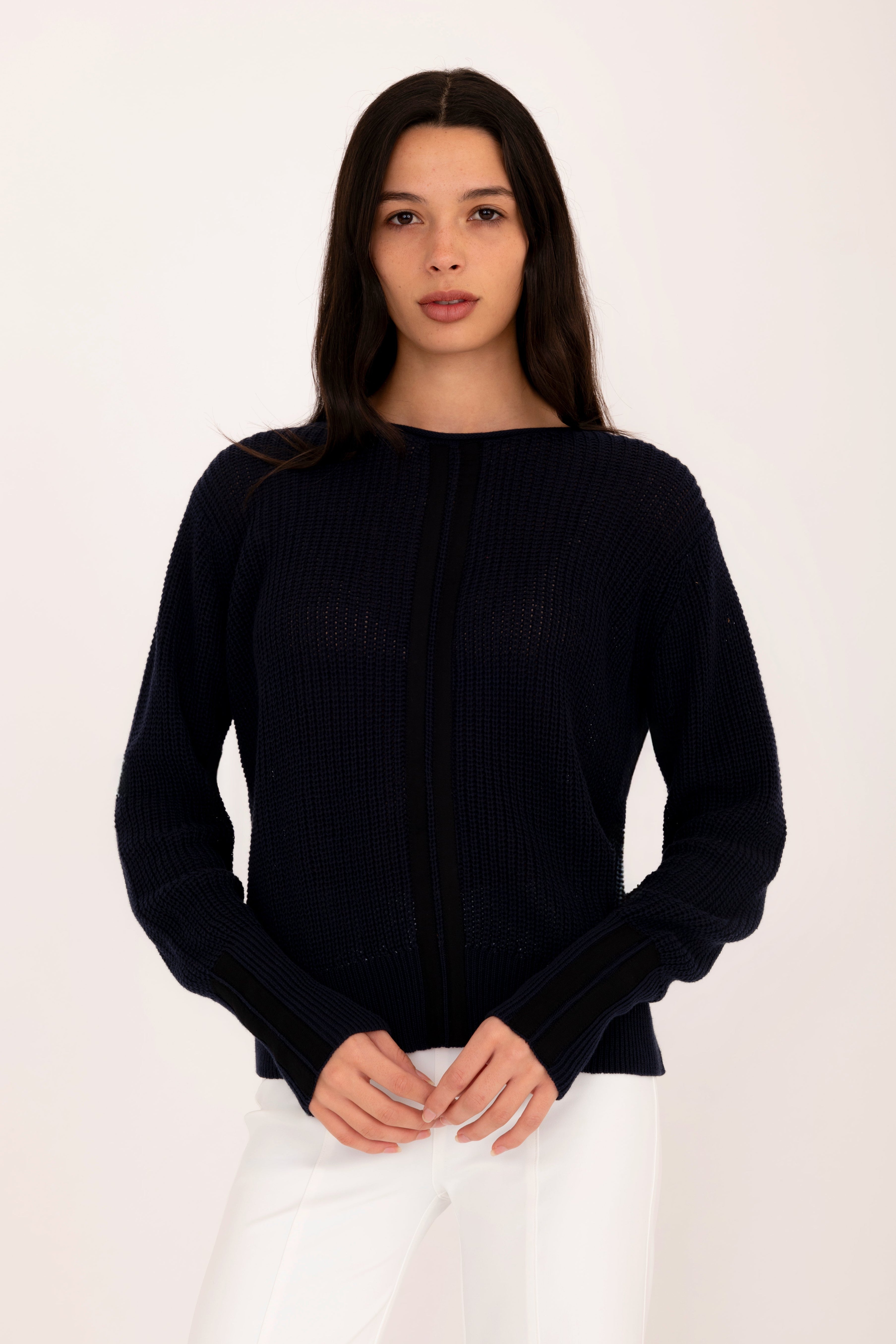 Woman wearing a black sweater on a white background