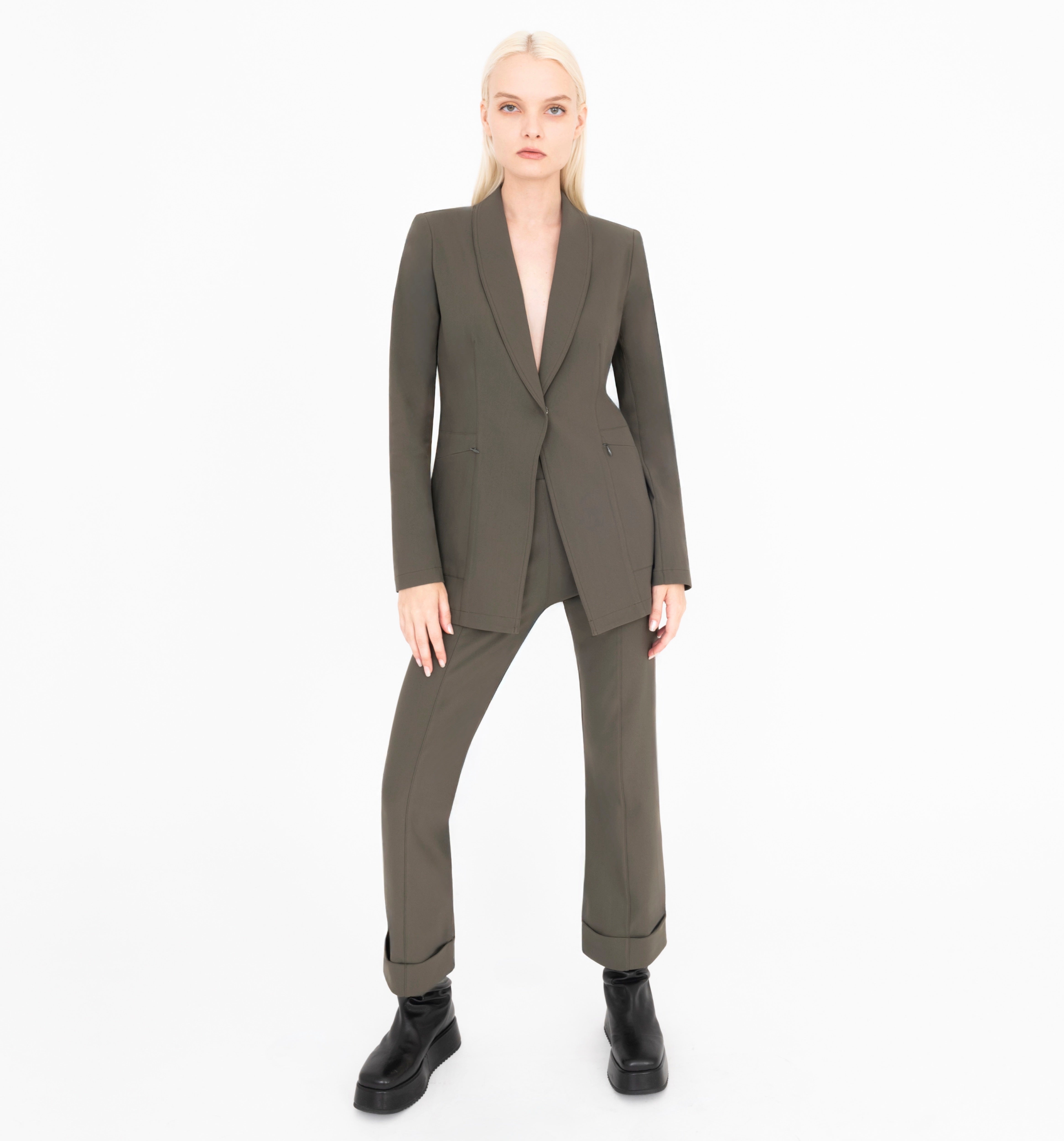 Woman wearing a green suit on a white background