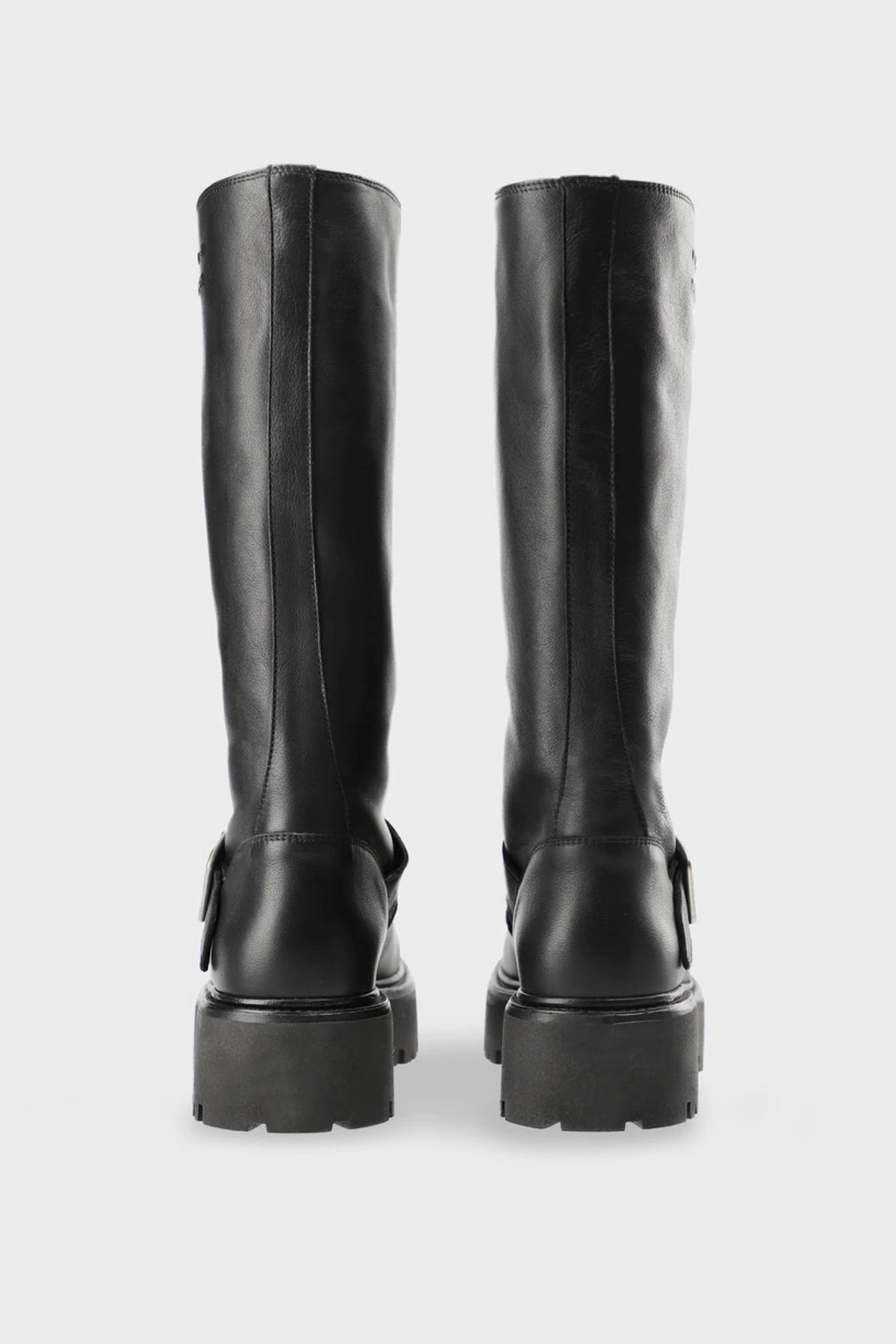 A pair of black leather knee-high boots with chunky lug soles, shown from the back against a light gray background.