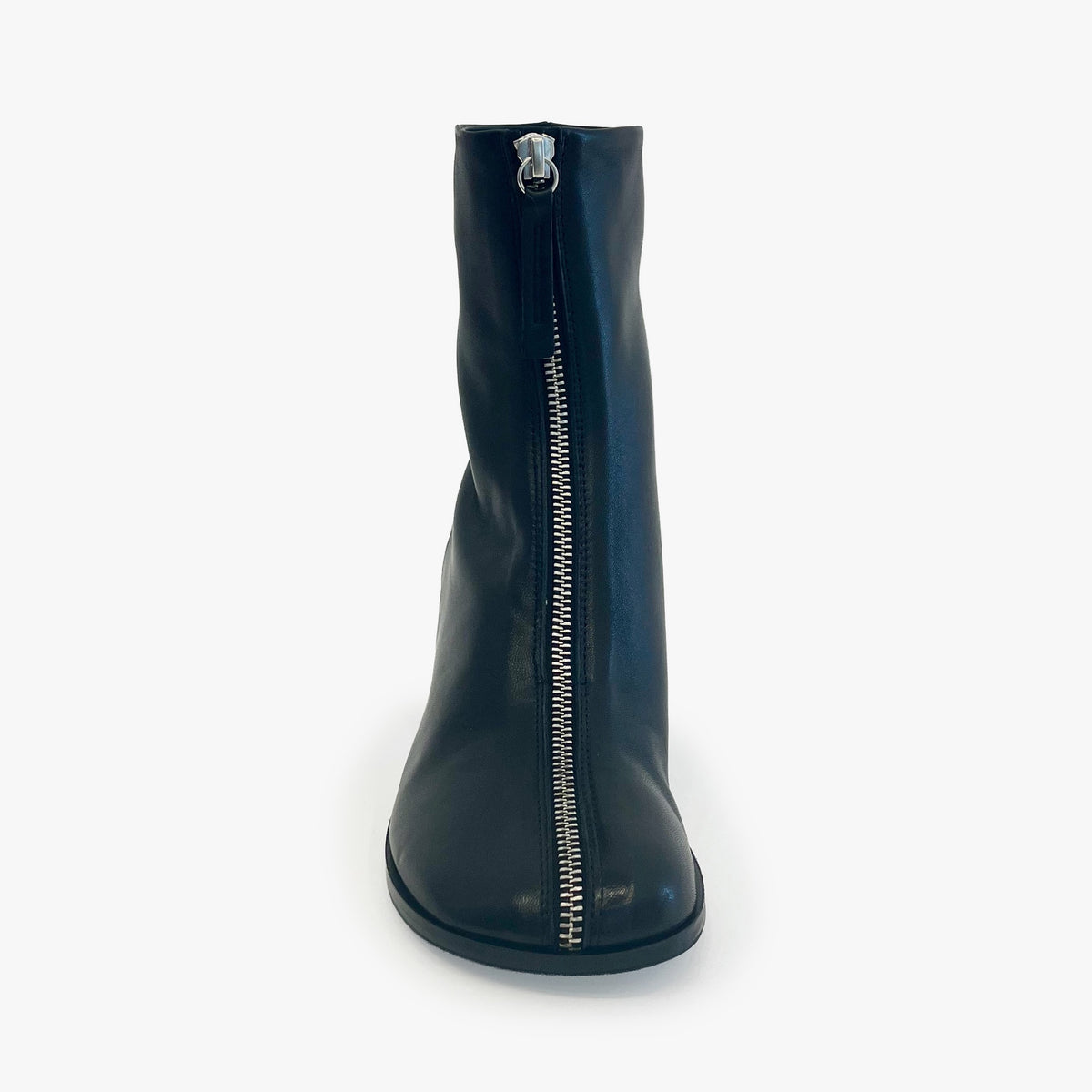 A single black leather ankle boot with a prominent silver zipper running down the center front, shown against a plain white background.