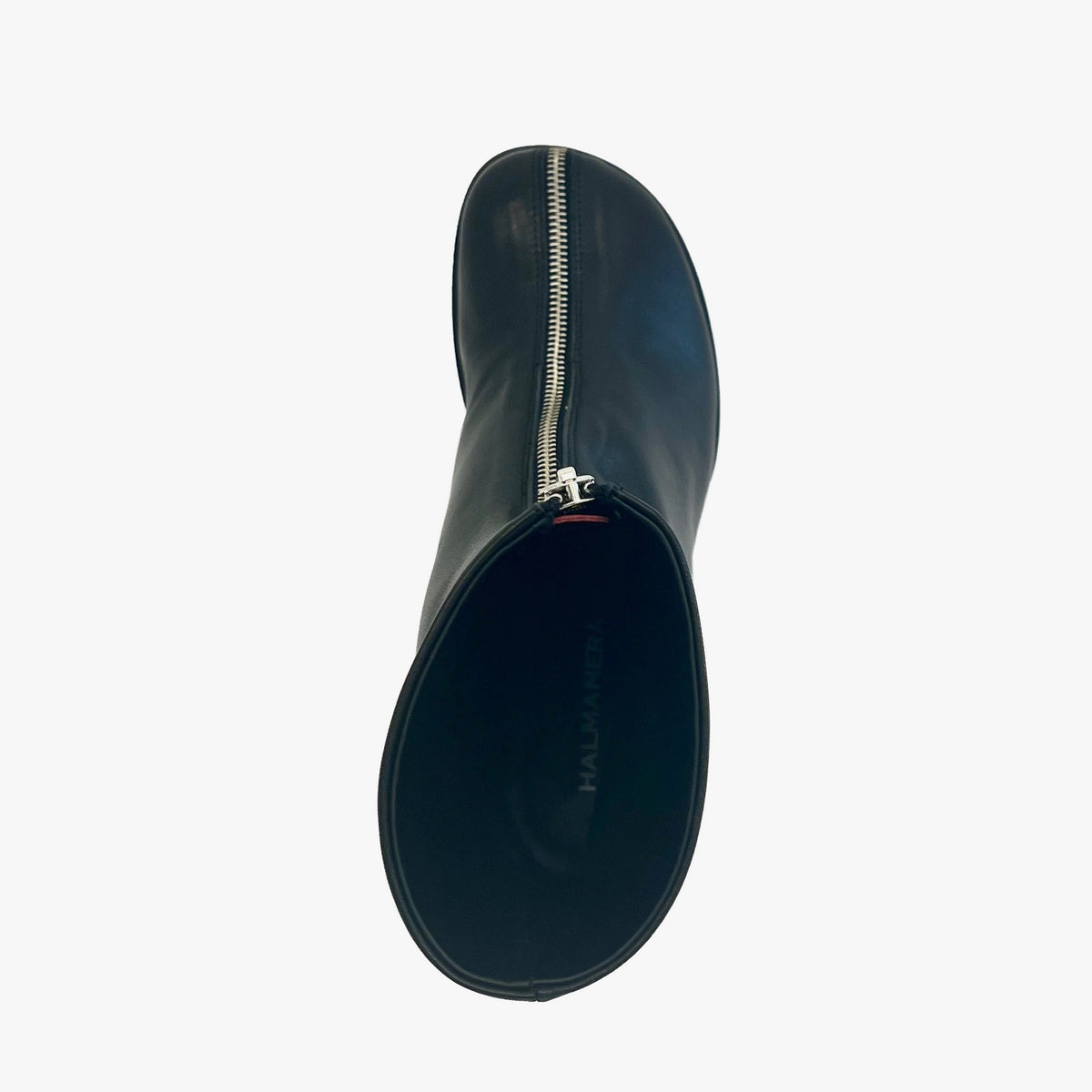 A single black leather boot shown from a top-down angle, featuring a prominent silver metal zipper running down the center of the shaft. 