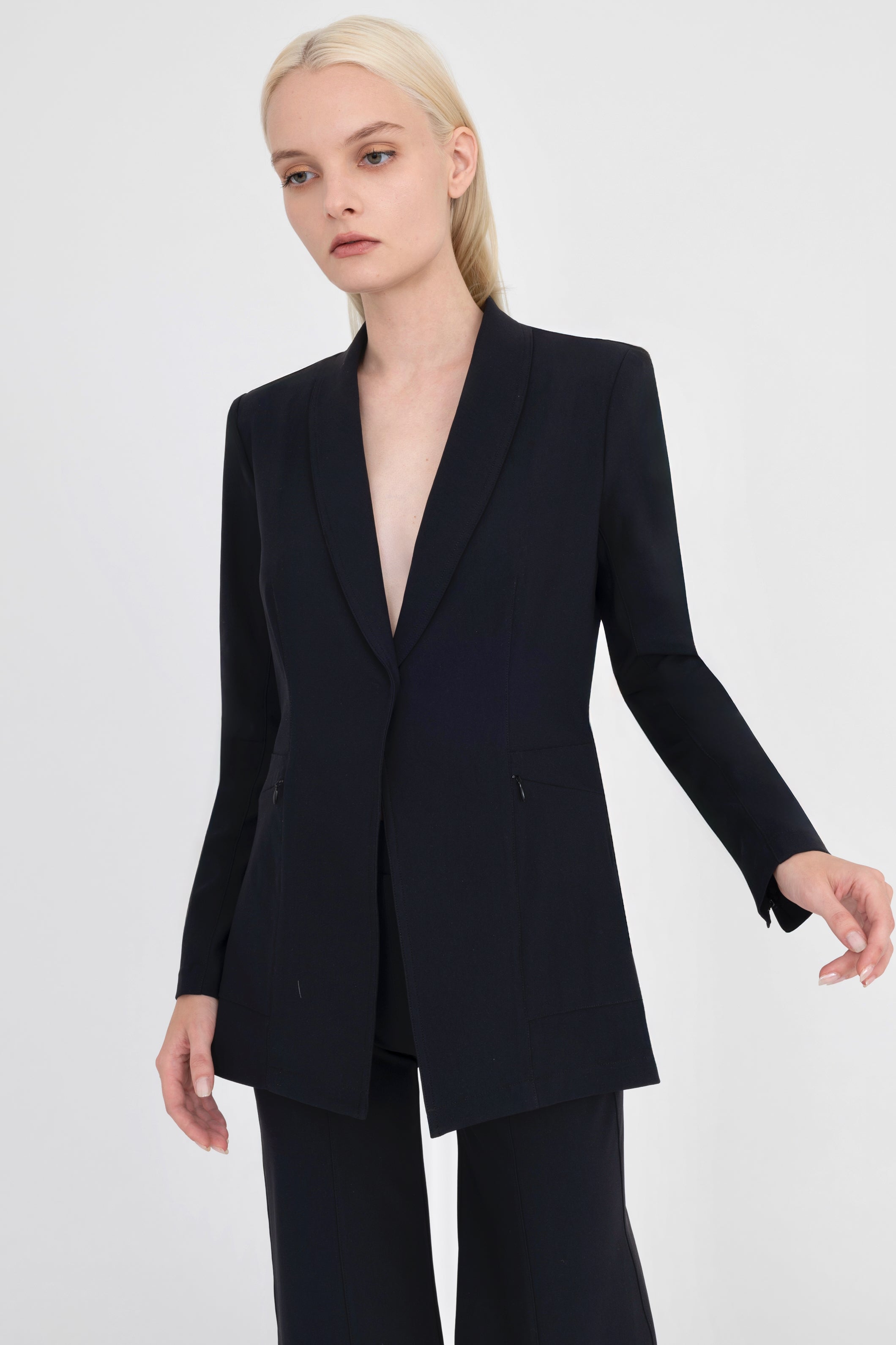 Woman wearing black blazer on a white background