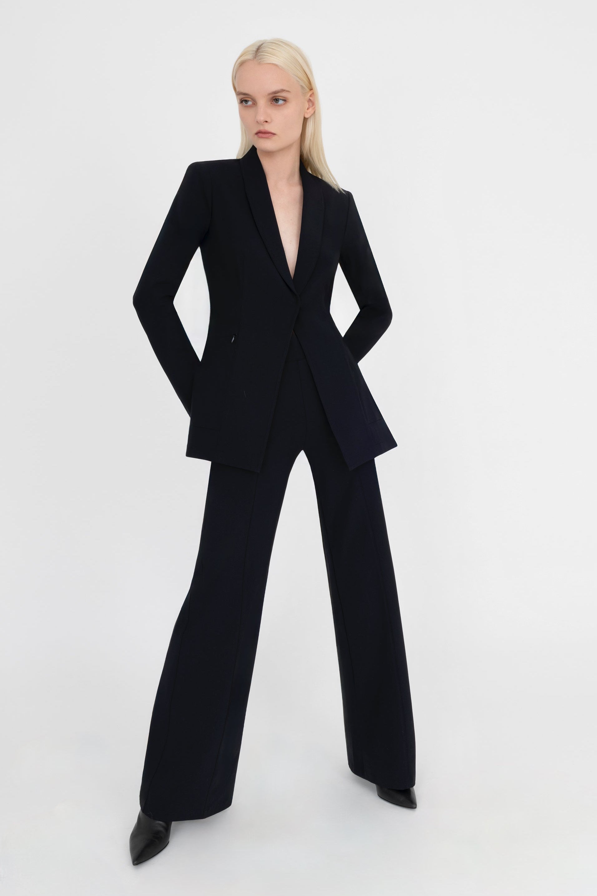 Woman wearing black suit on a white background