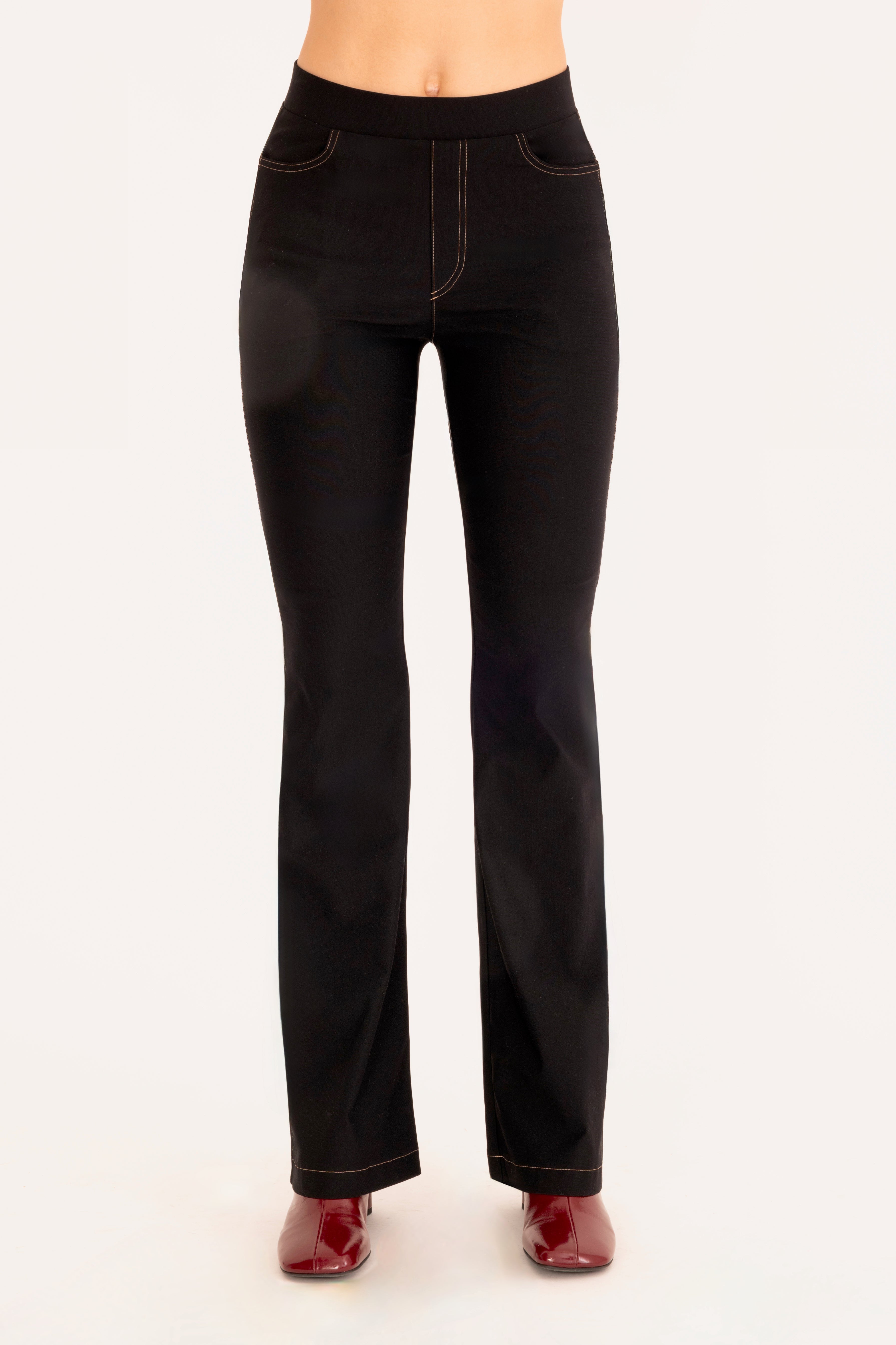Front view of black flare jean pants on a white background