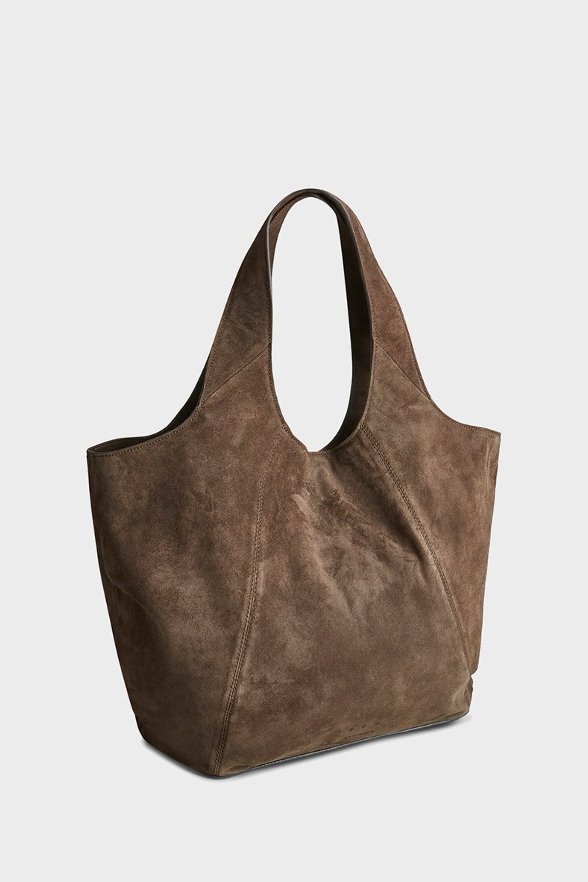 A brown suede tote bag with a slouchy, open-top silhouette and two shoulder straps, shown on a light gray background.