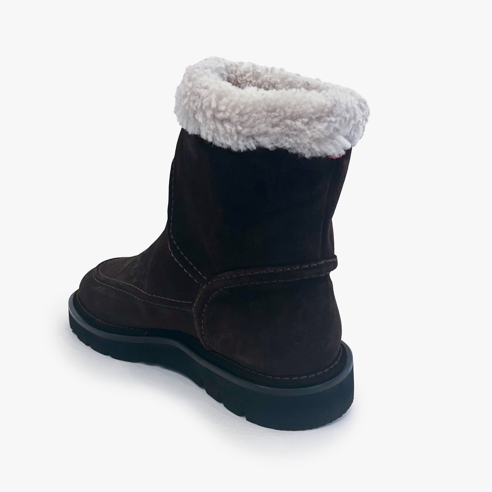 A dark brown suede ankle boot with a thick black sole and a fluffy white faux-fur collar, shown from a rear three-quarter angle on a light gray background.