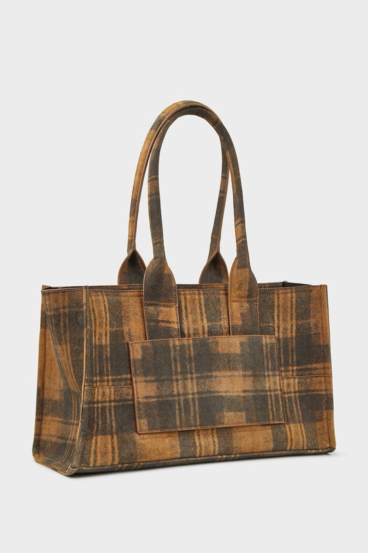 A rectangular suede tote bag with a brown and tan plaid pattern, featuring two top handles and a front pocket, shown against a light gray background.