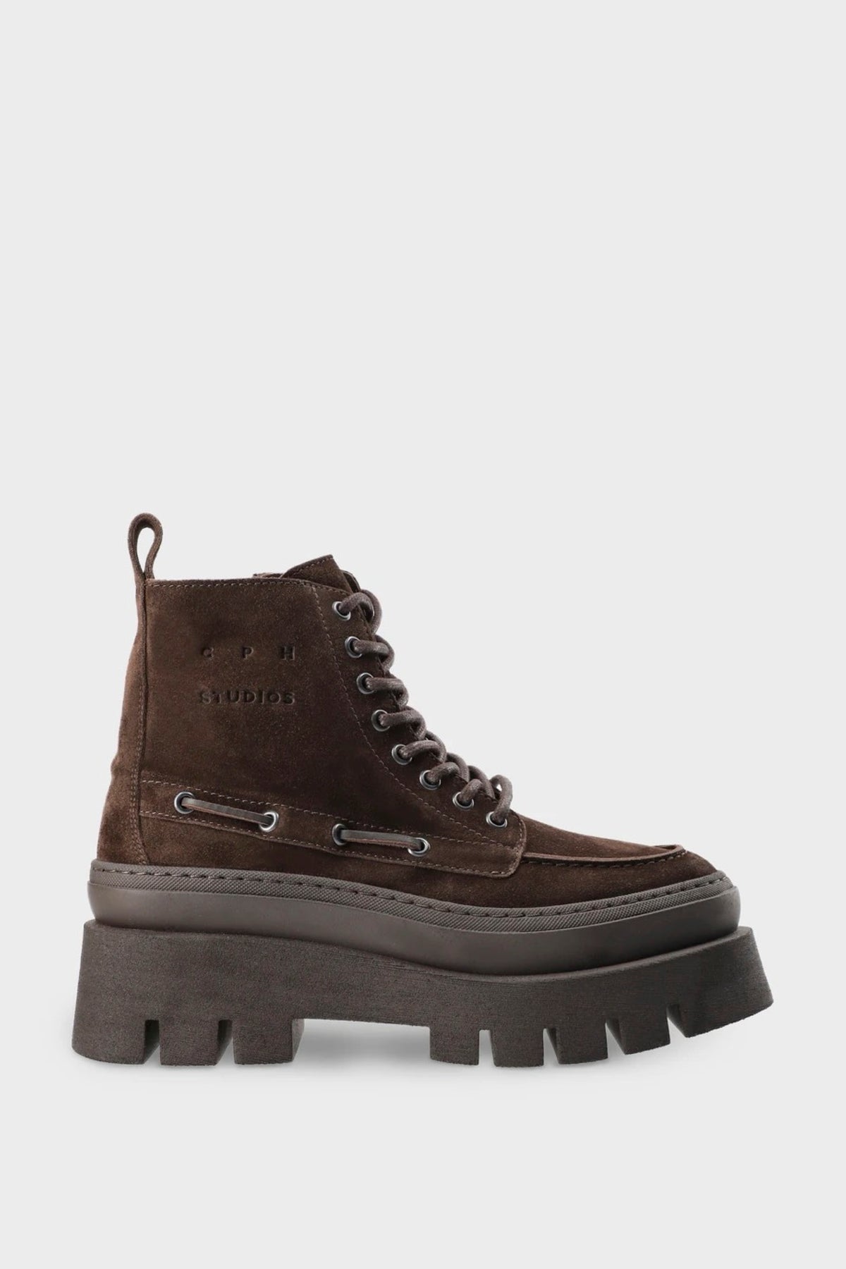 A dark brown suede lace-up ankle boot with a chunky black lug sole, shown from a side profile on a light gray background.