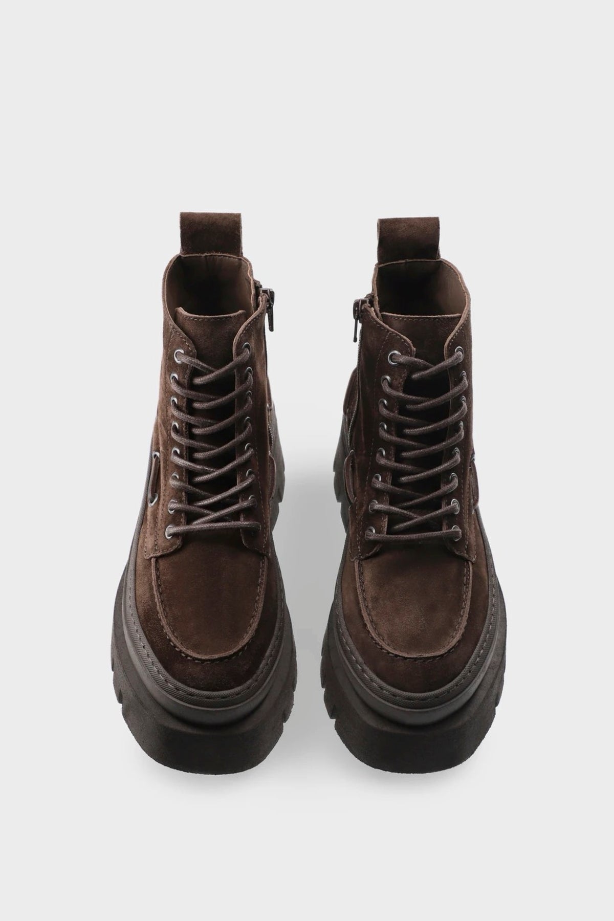 A pair of dark brown suede lace-up ankle boots with chunky black platform soles, shown from a top-down view on a light gray background.