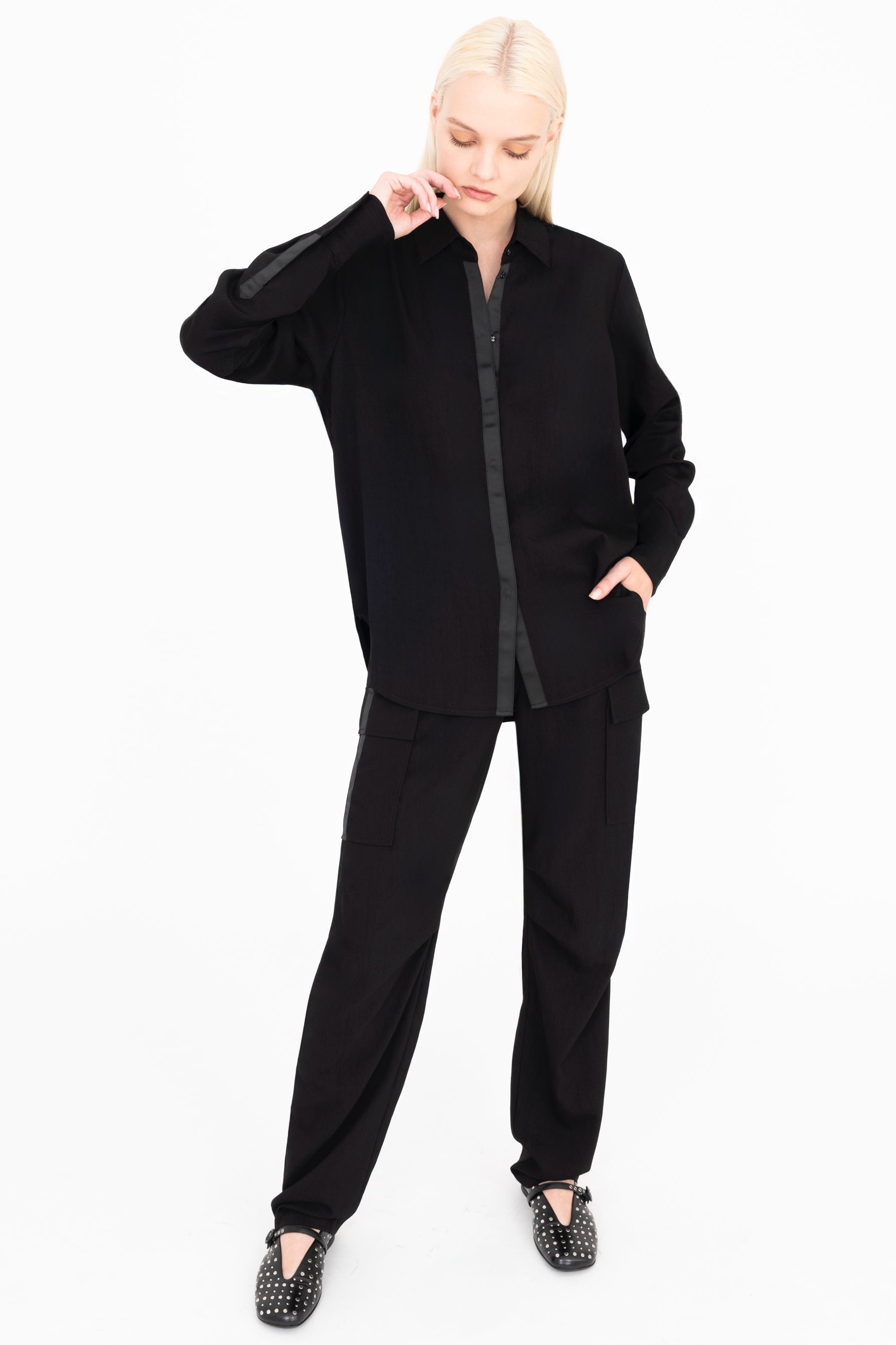 Person wearing a black outfit on a white background