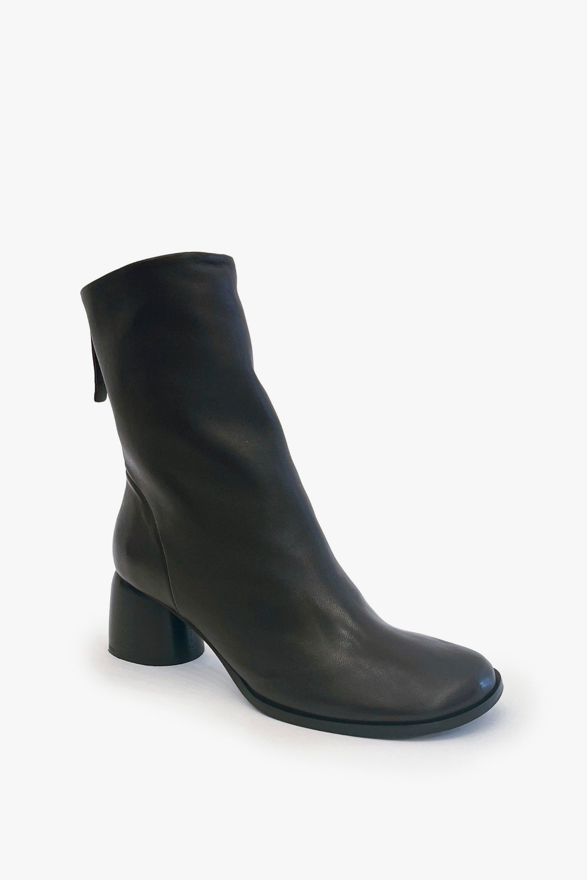 A single dark brown leather ankle boot with a low block heel and rounded toe, photographed from a three-quarters angle against a clean white background.