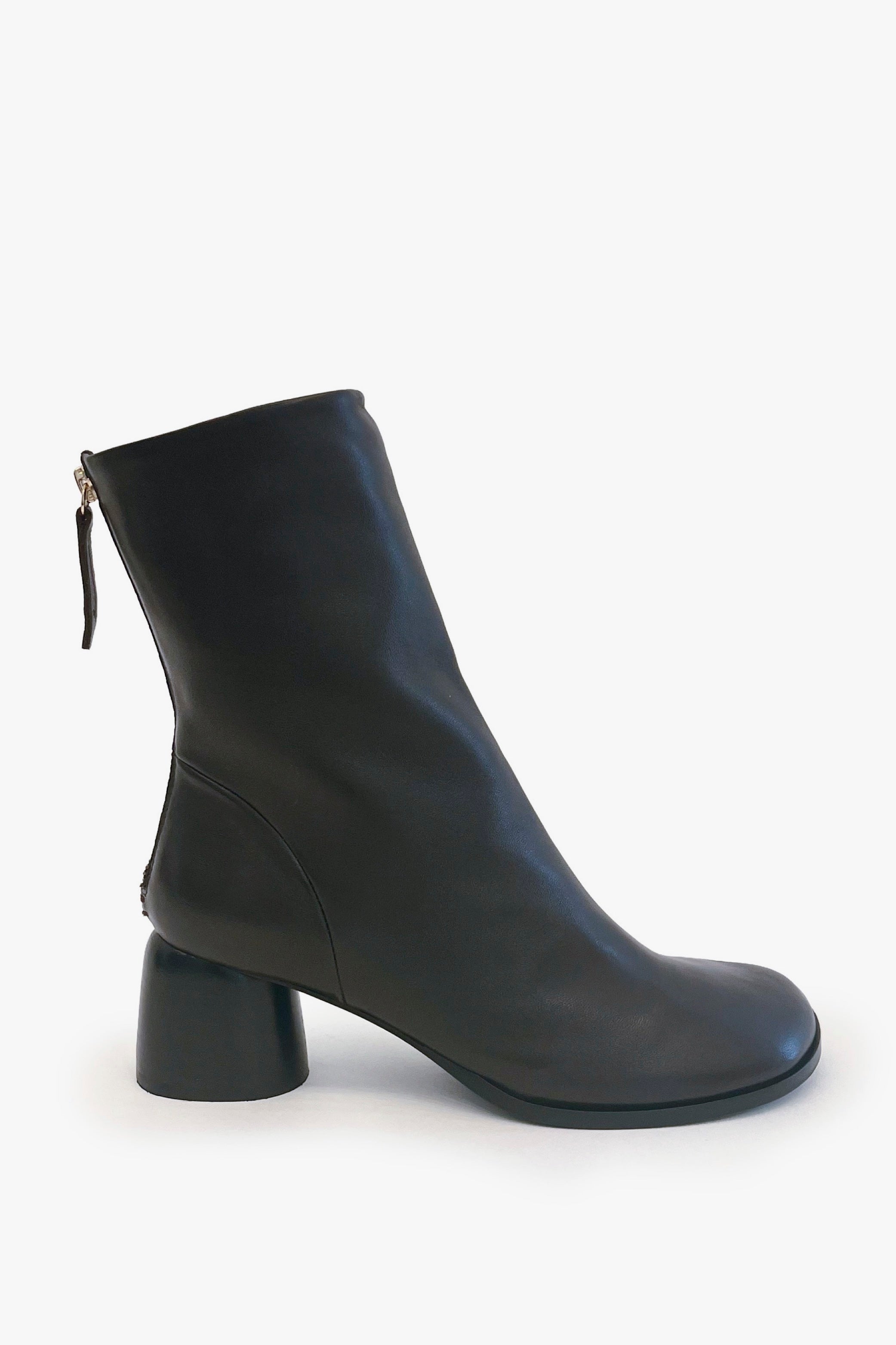 A dark brown leather ankle boot with a low block heel and a back zipper, shown from a side profile on a light gray background.