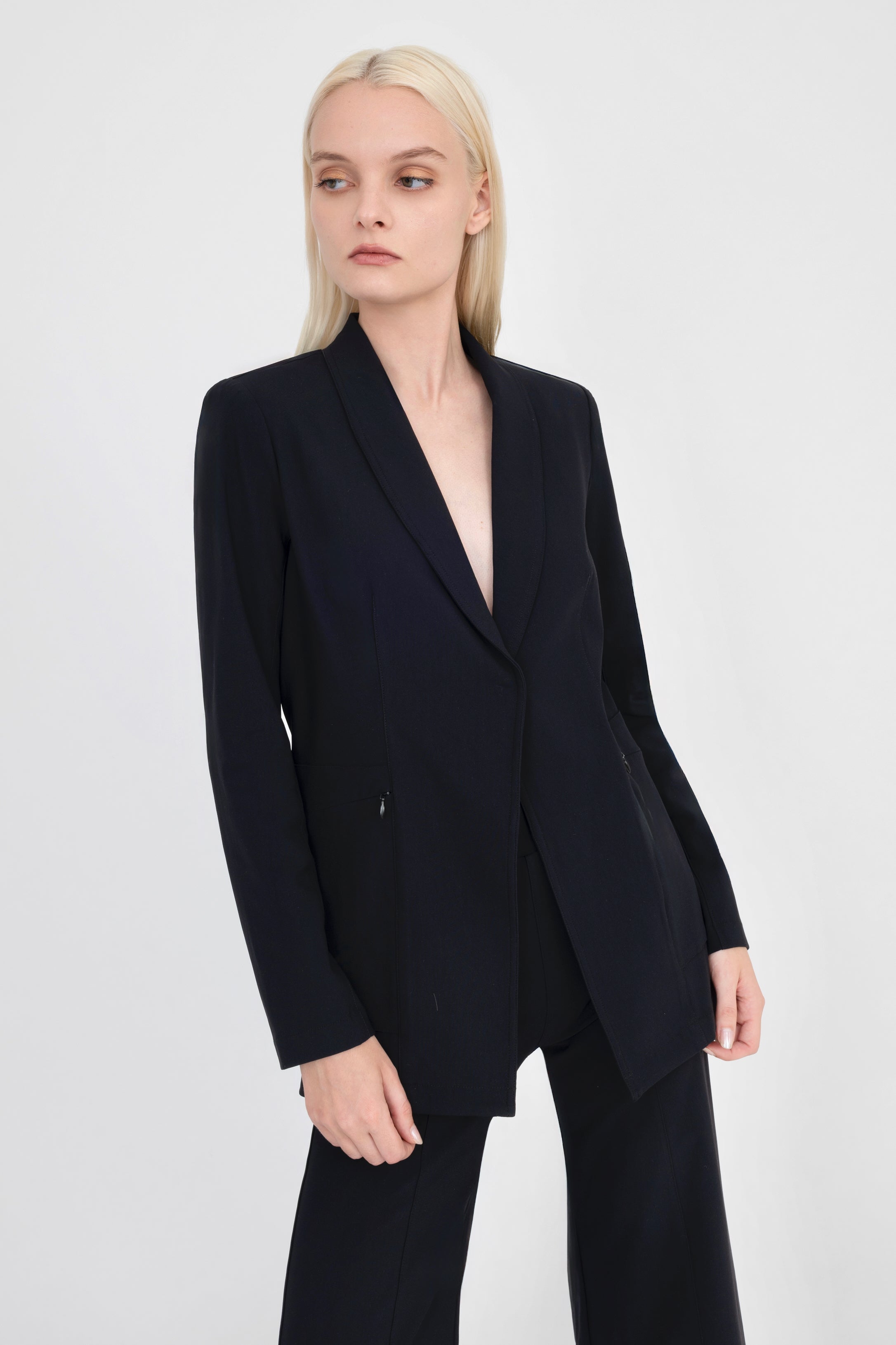 Woman wearing black blazer on a white background