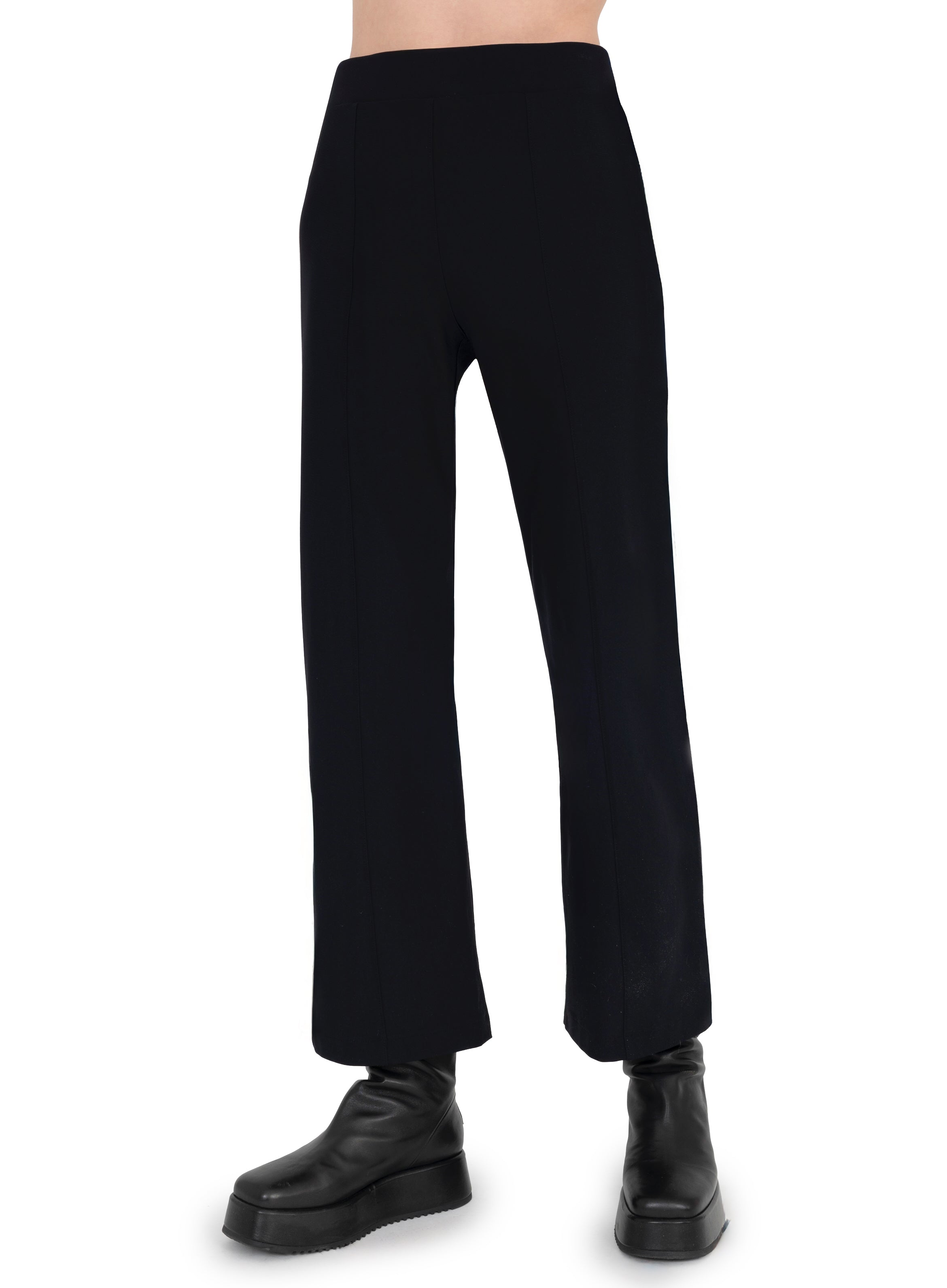 Black pants worn by a person on a white background