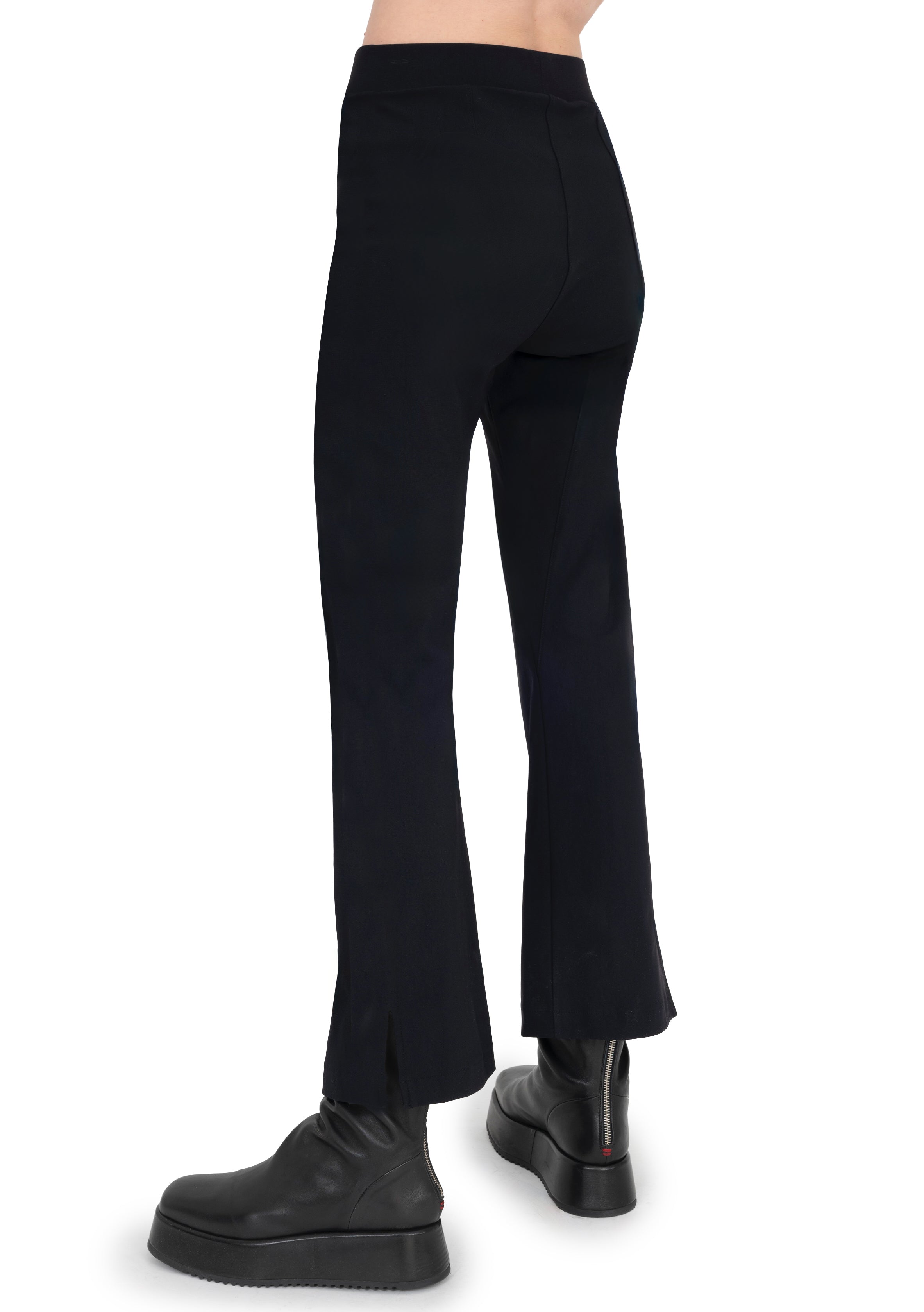 Black pants worn by a person on a white background