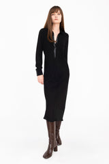 Woman wearing a black dress and boots on a white background